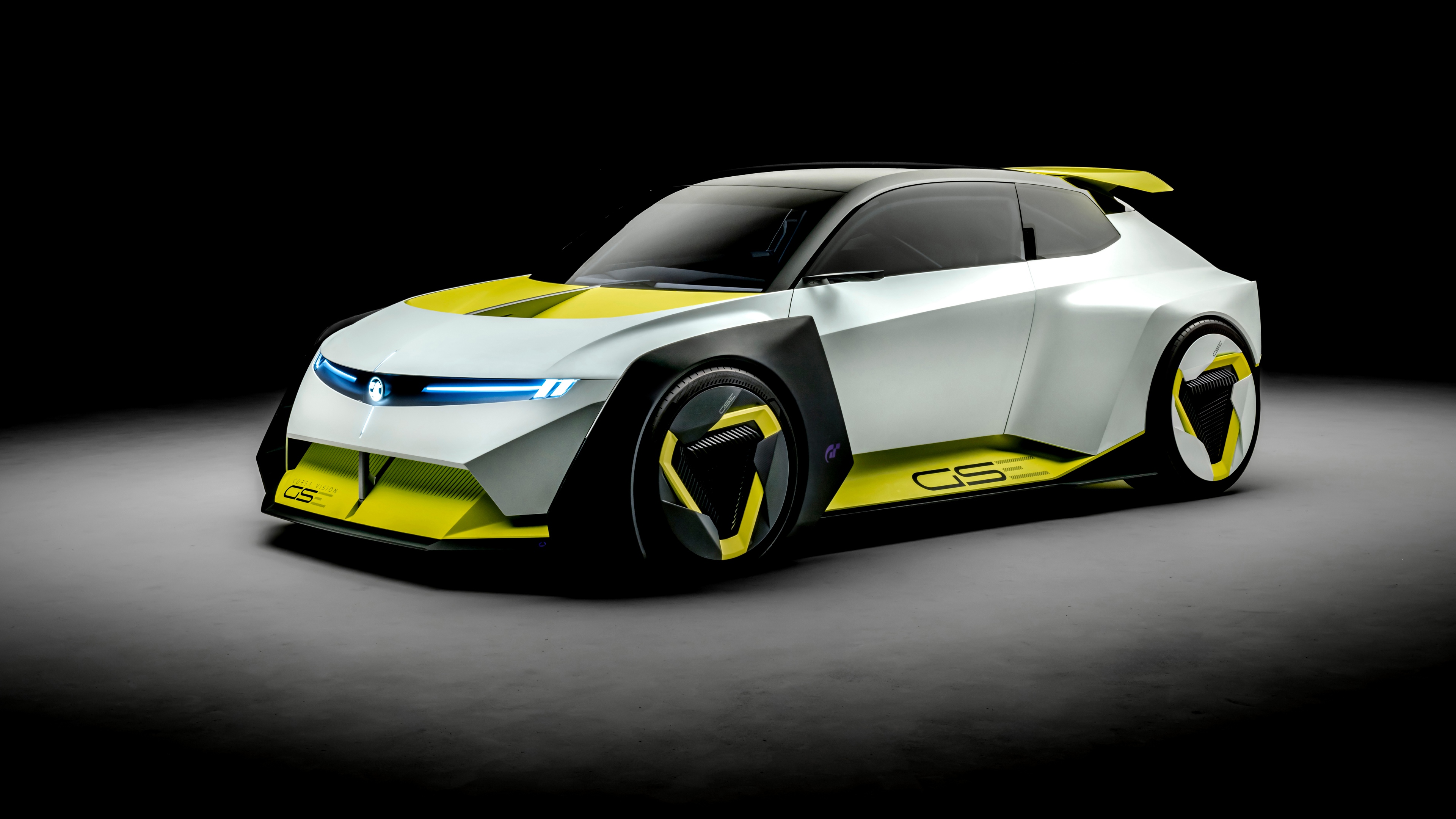 A sleek, futuristic concept car with glowing accents parked against a dark, minimalist studio background.