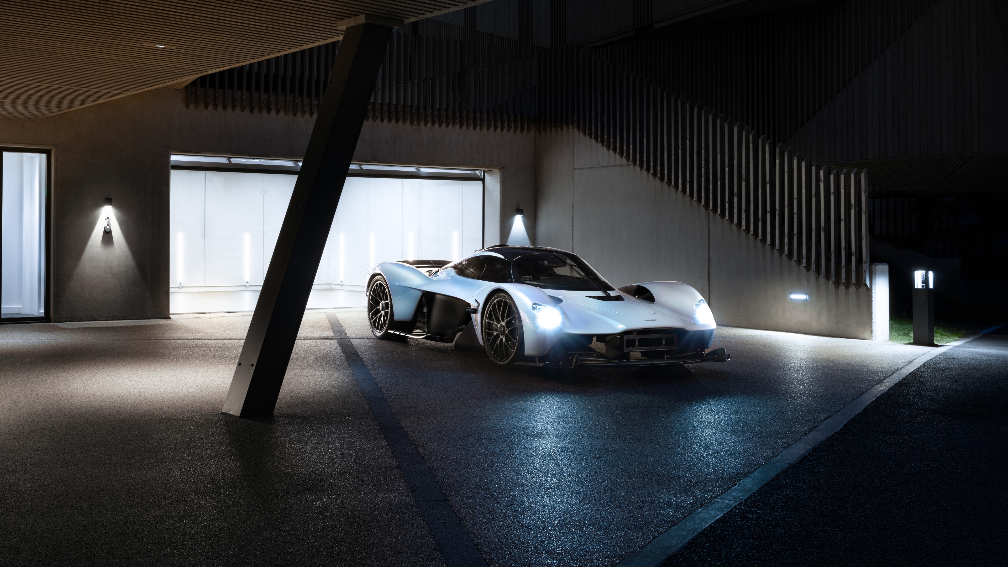 A highly detailed, futuristic view of the Aston Martin Valkyrie hybrid sports car featuring aerodynamic curves and sleek design.
