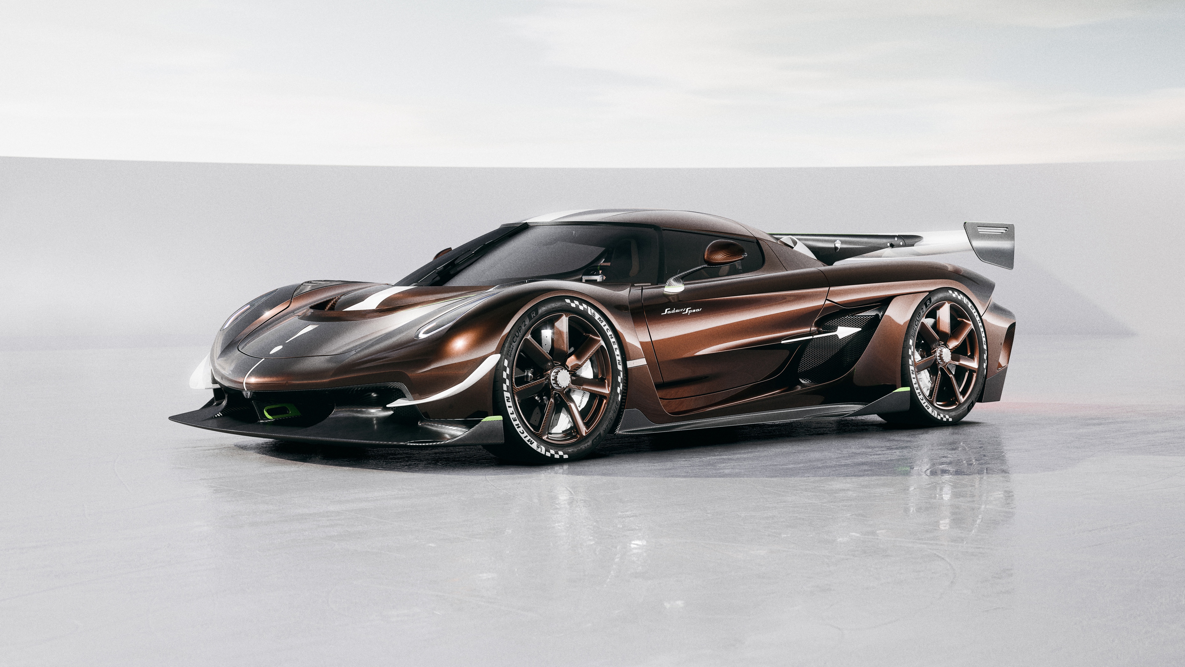 A hyper-realistic view of the 2025 Koenigsegg Sadair's Spear hypercar, featuring a sleek aerodynamic design and futuristic automotive engineering.
