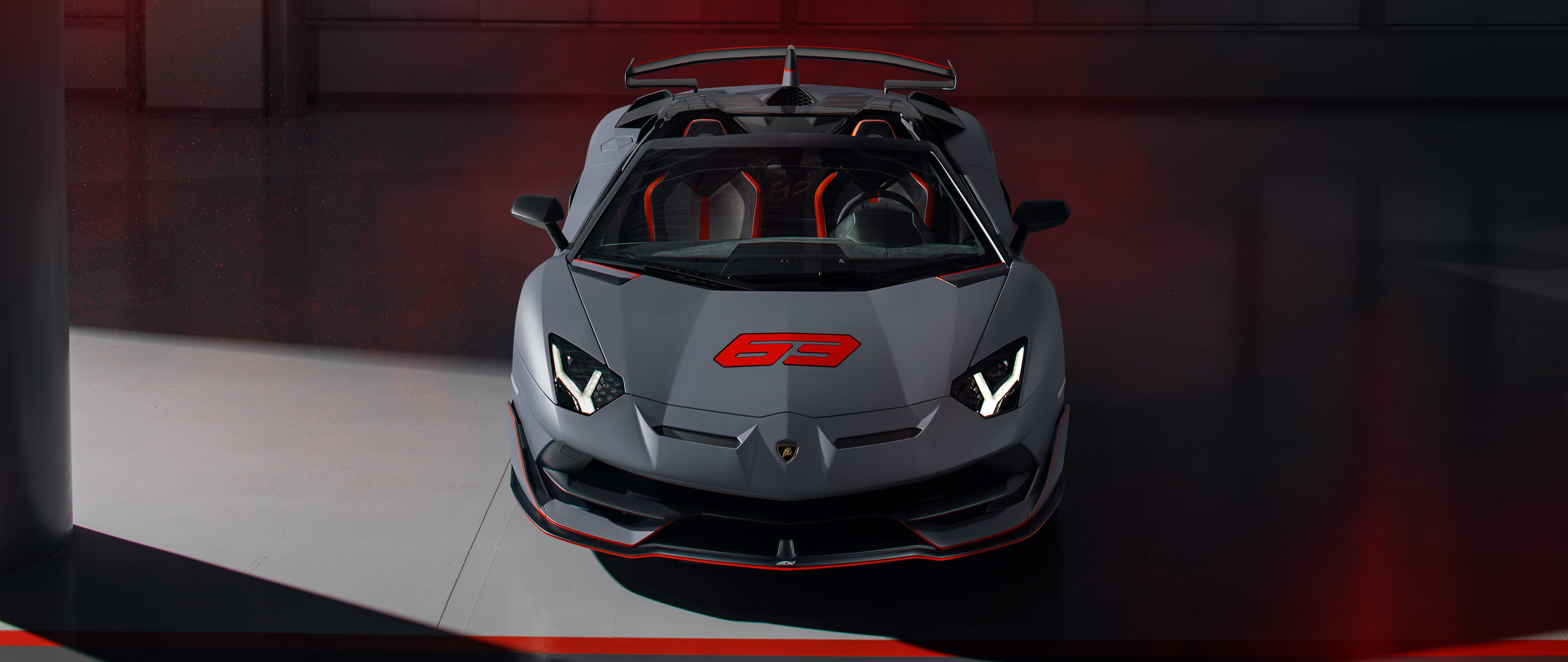 A sleek, metallic silver Lamborghini Aventador SVJ supercar featuring aggressive aerodynamic bodywork.