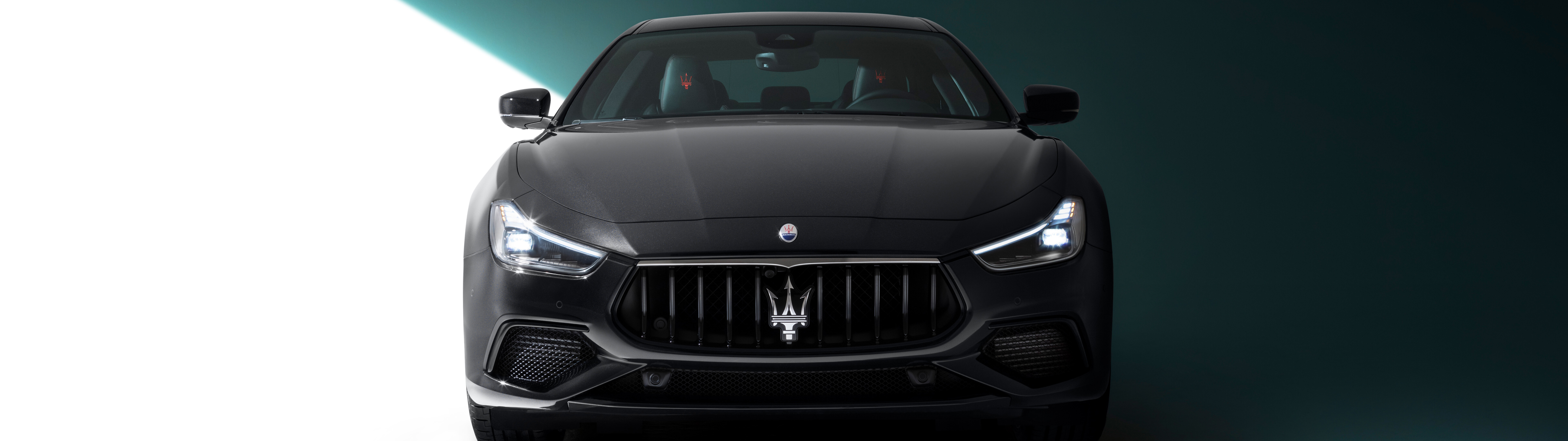 A high-end black Maserati Ghibli featuring a polished, sleek automotive design.