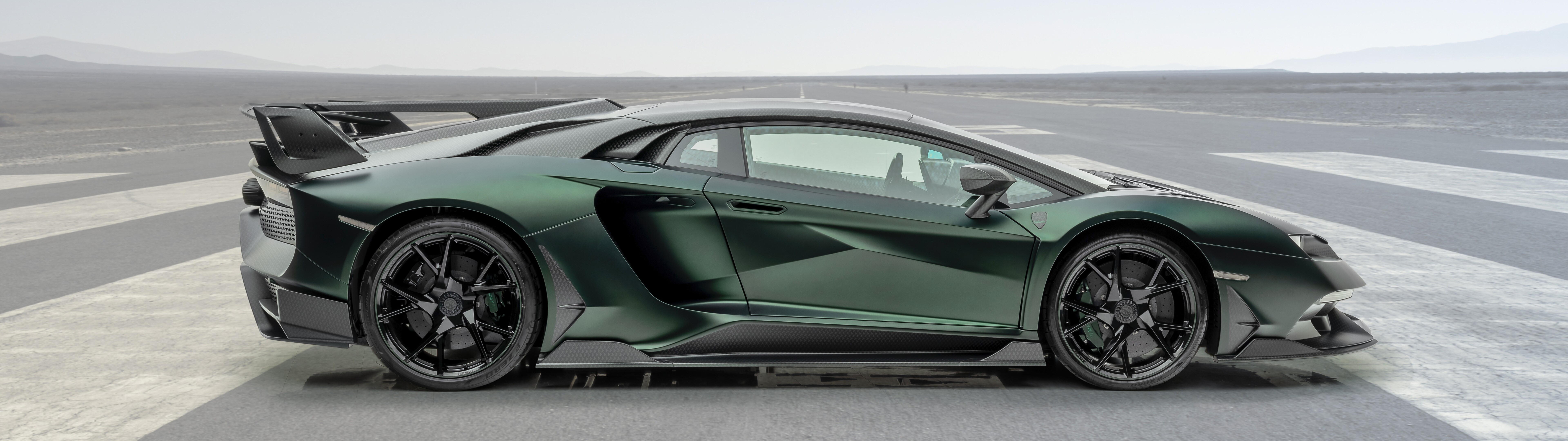 A high-performance Mansory Cabrera Lamborghini Aventador SVJ with custom aerodynamic body kit and carbon fiber details.