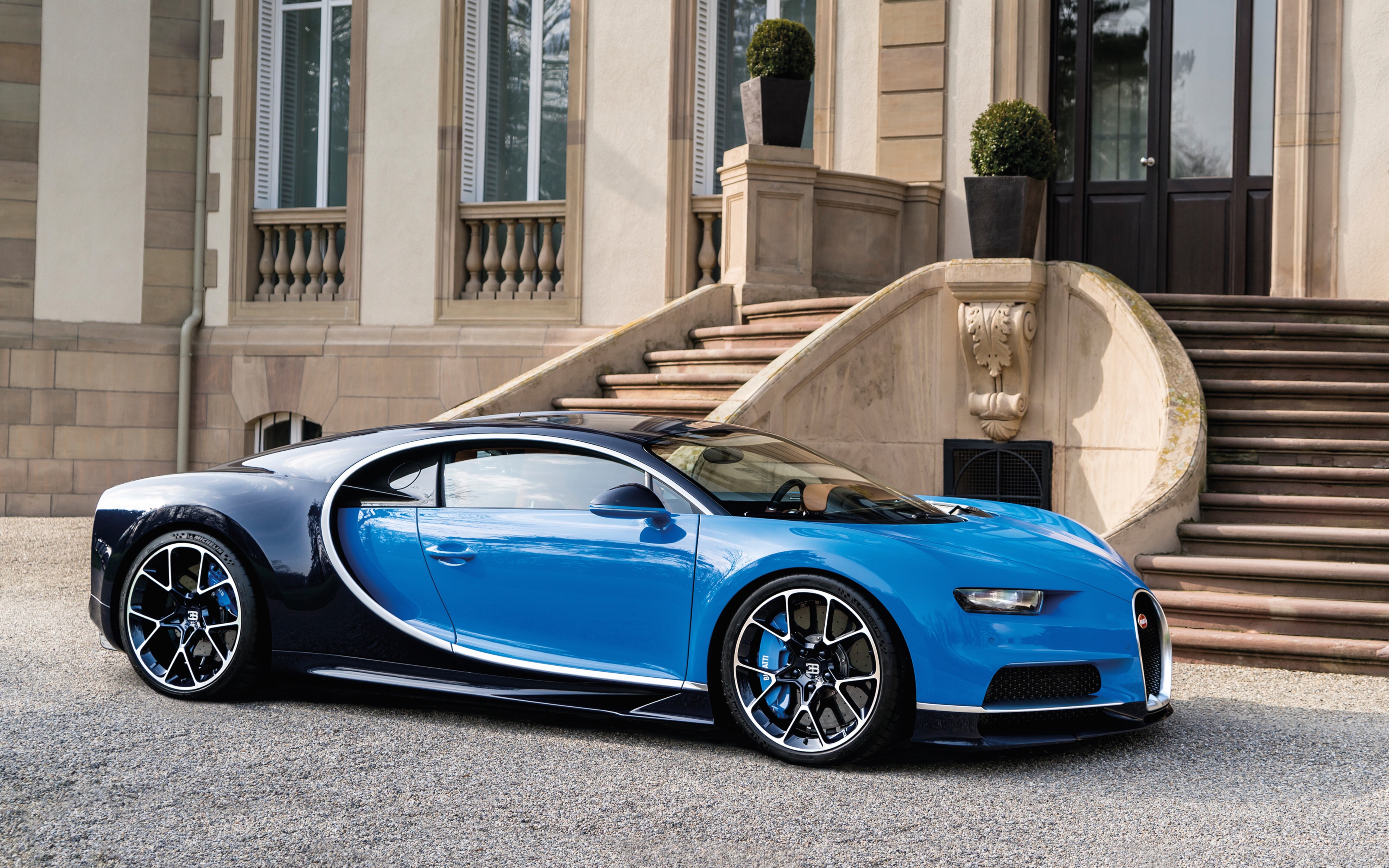 A high-performance Bugatti Chiron supercar featuring sleek aerodynamic lines and a premium polished finish.