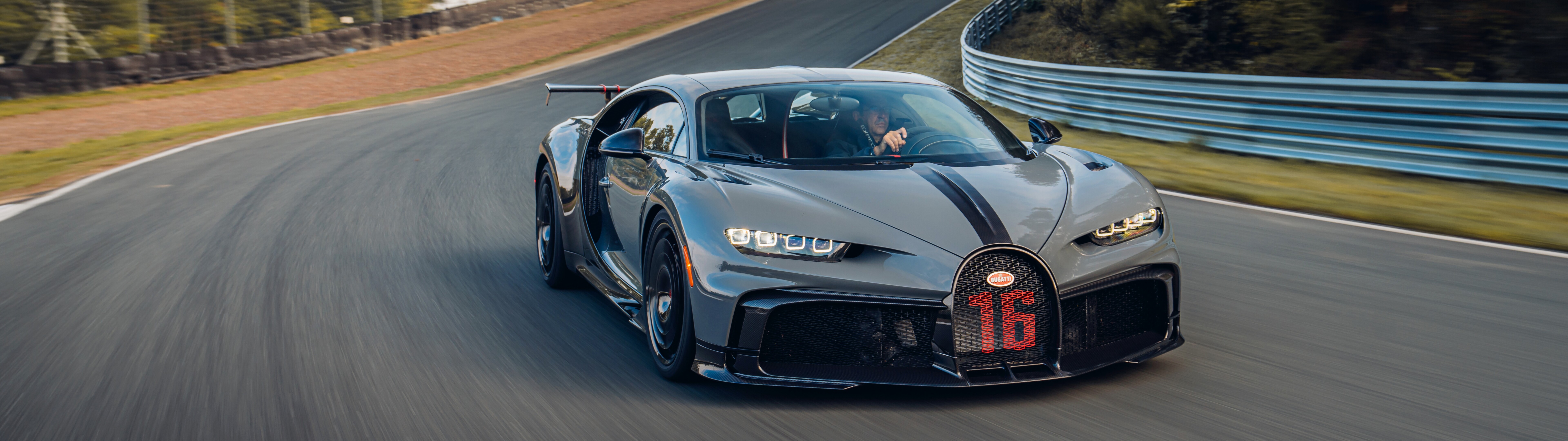 A detailed view of a Bugatti Chiron Pur Sport supercar featuring its iconic aerodynamic body and premium finish.