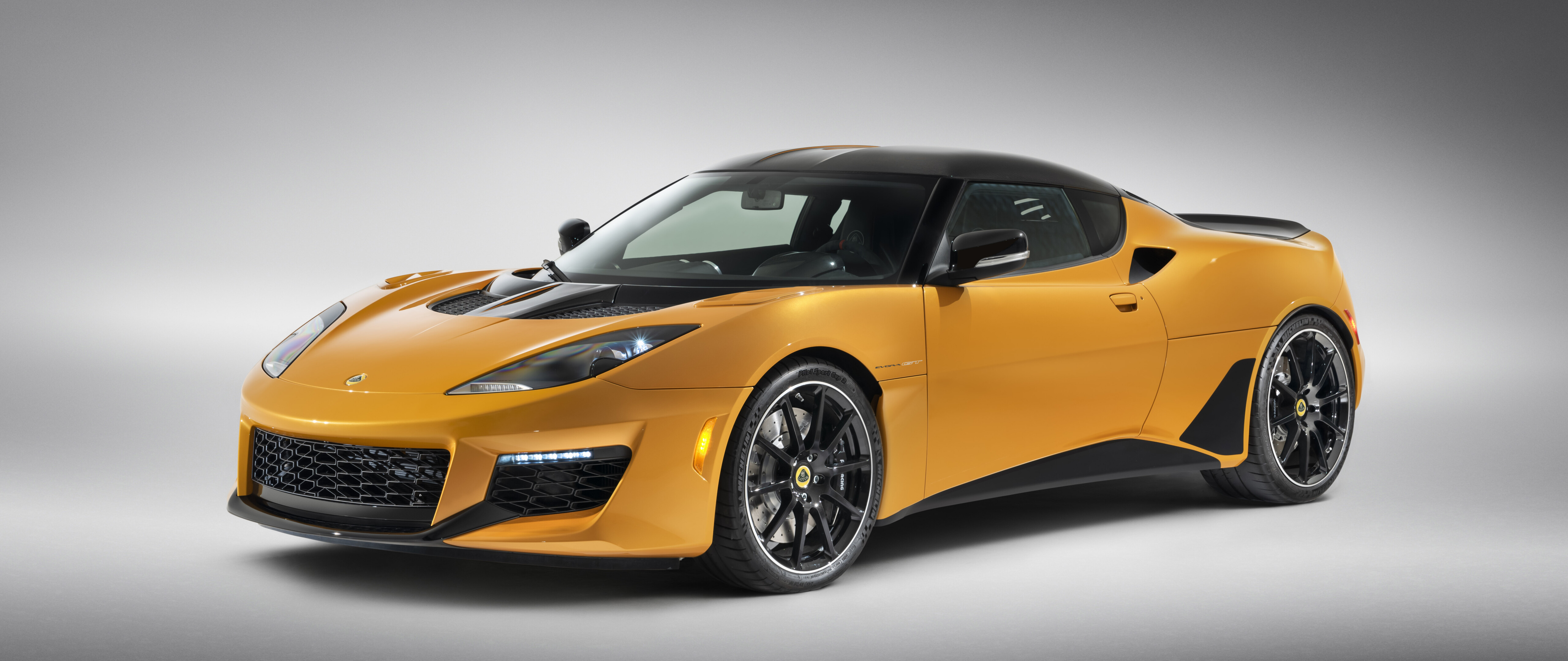 A vibrant orange Lotus Evora GT supercar featuring sleek aerodynamic curves.