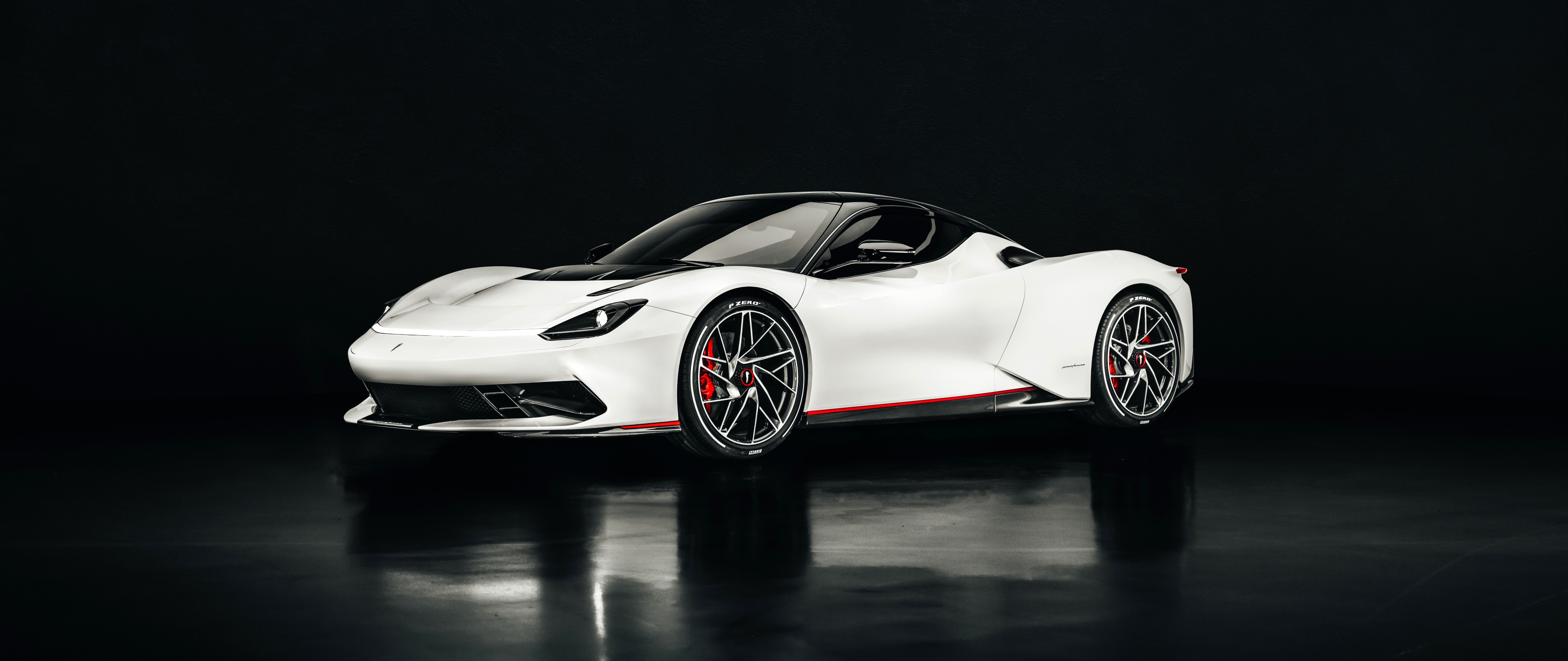 A sleek white Pininfarina Battista electric hypercar with aerodynamic curves.
