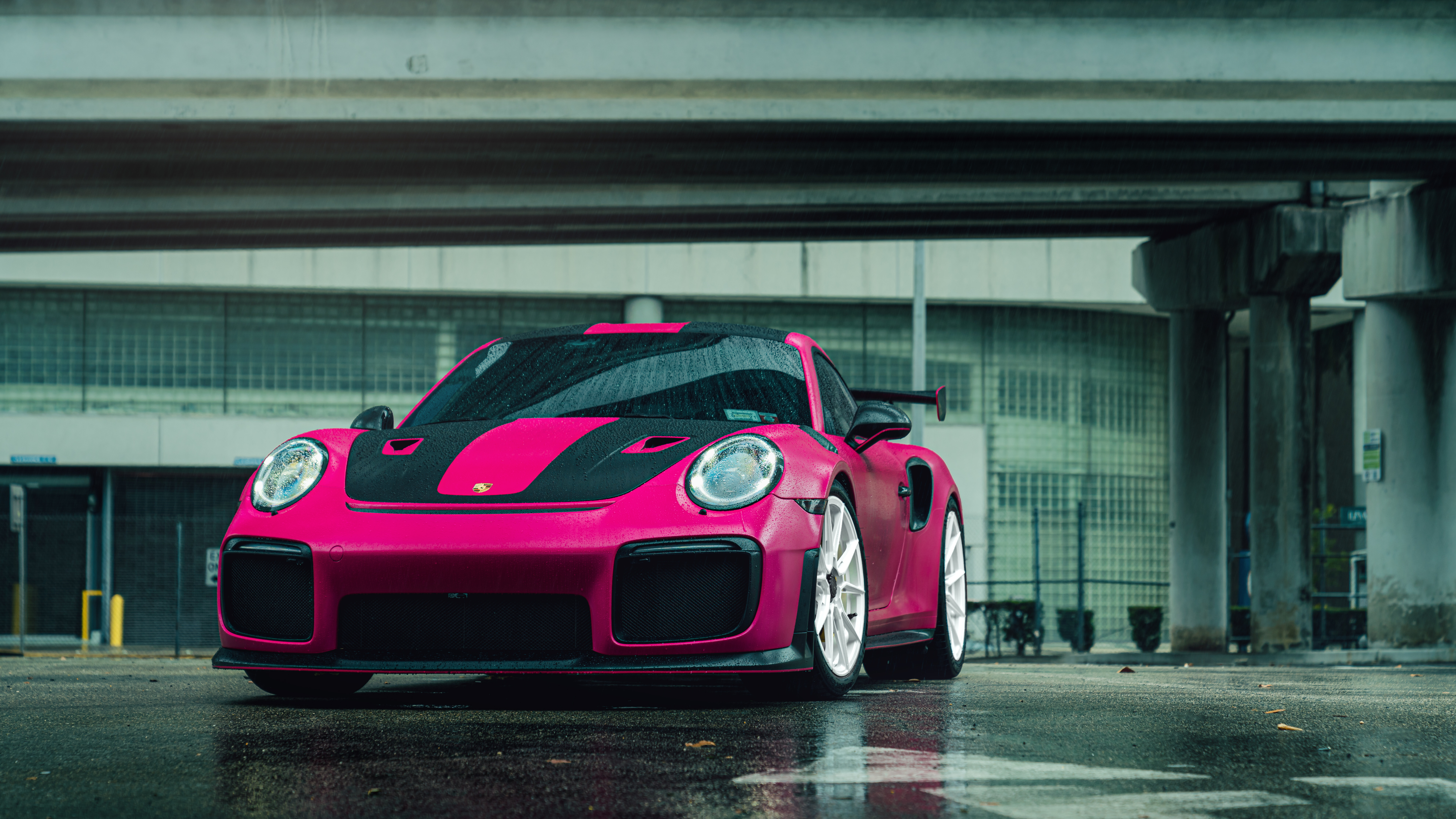 A vibrant pink Porsche 911 GT2 RS luxury sports car