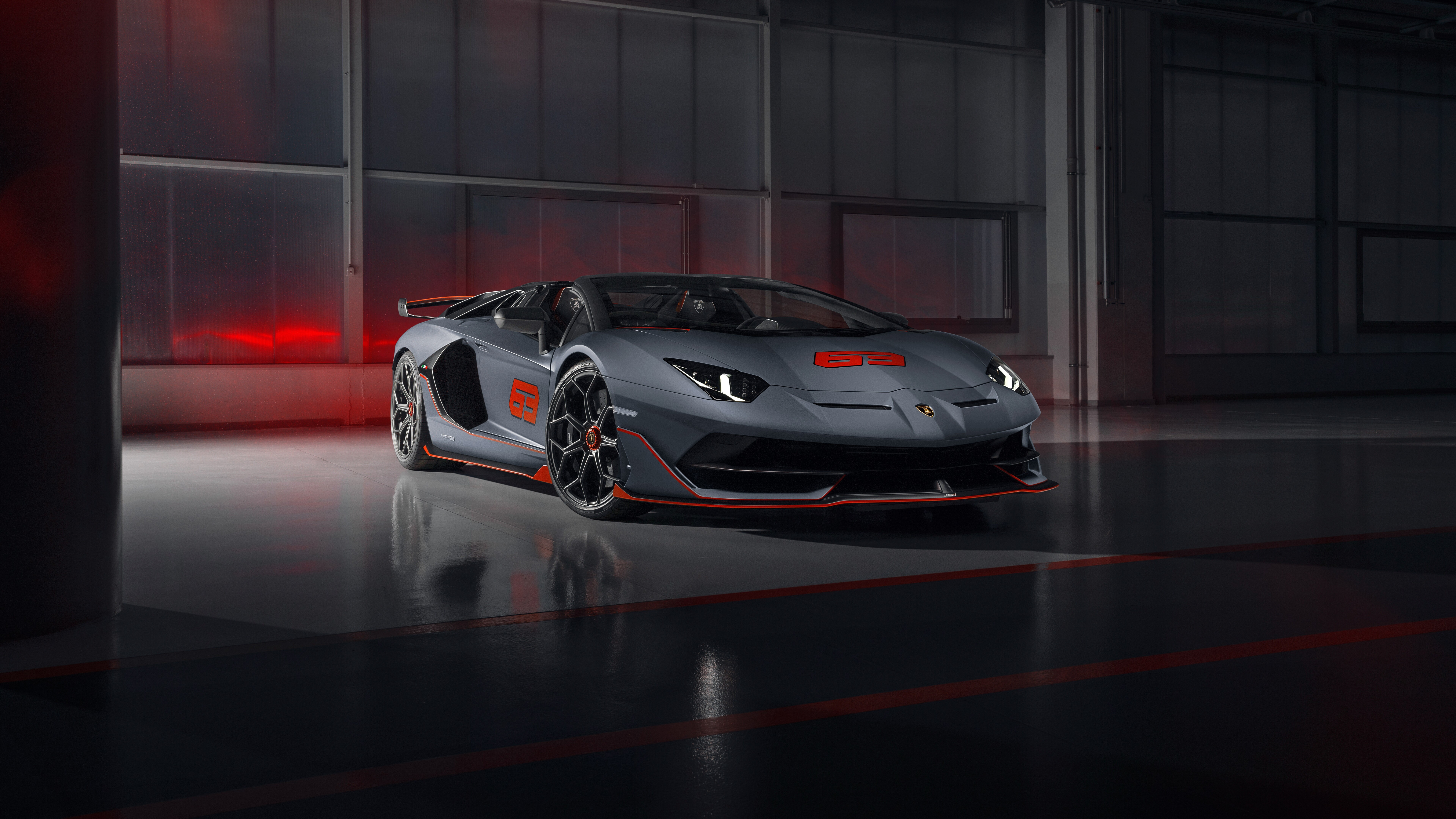 A sleek and powerful silver Lamborghini Aventador SVJ supercar showcasing its aerodynamic body.