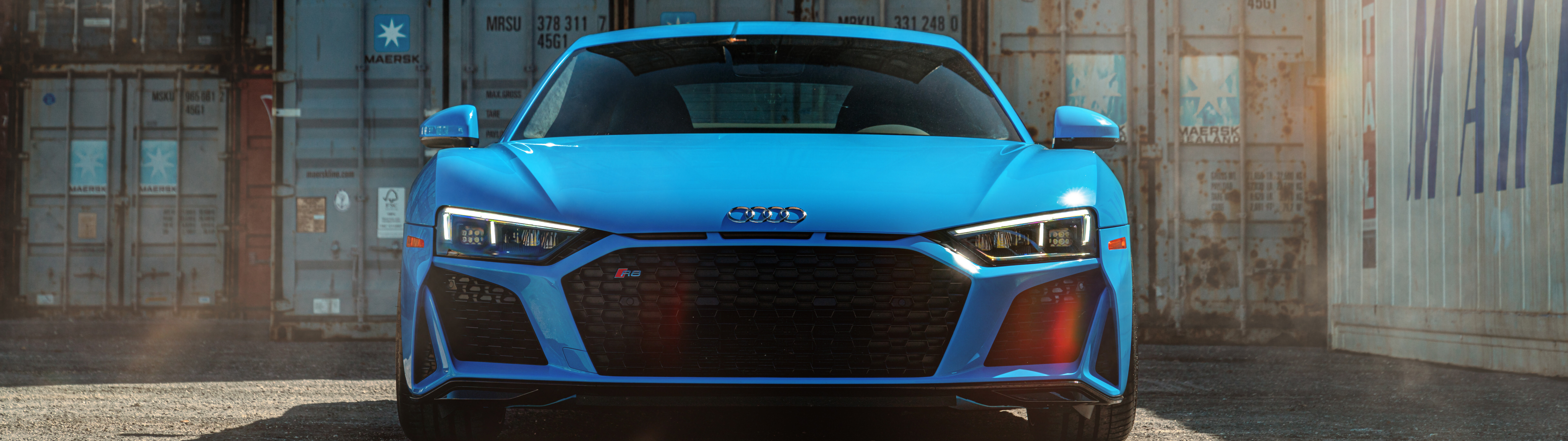A close-up, high-detail shot of a premium Audi R8 supercar highlighting its sleek aerodynamic body and sophisticated engineering.