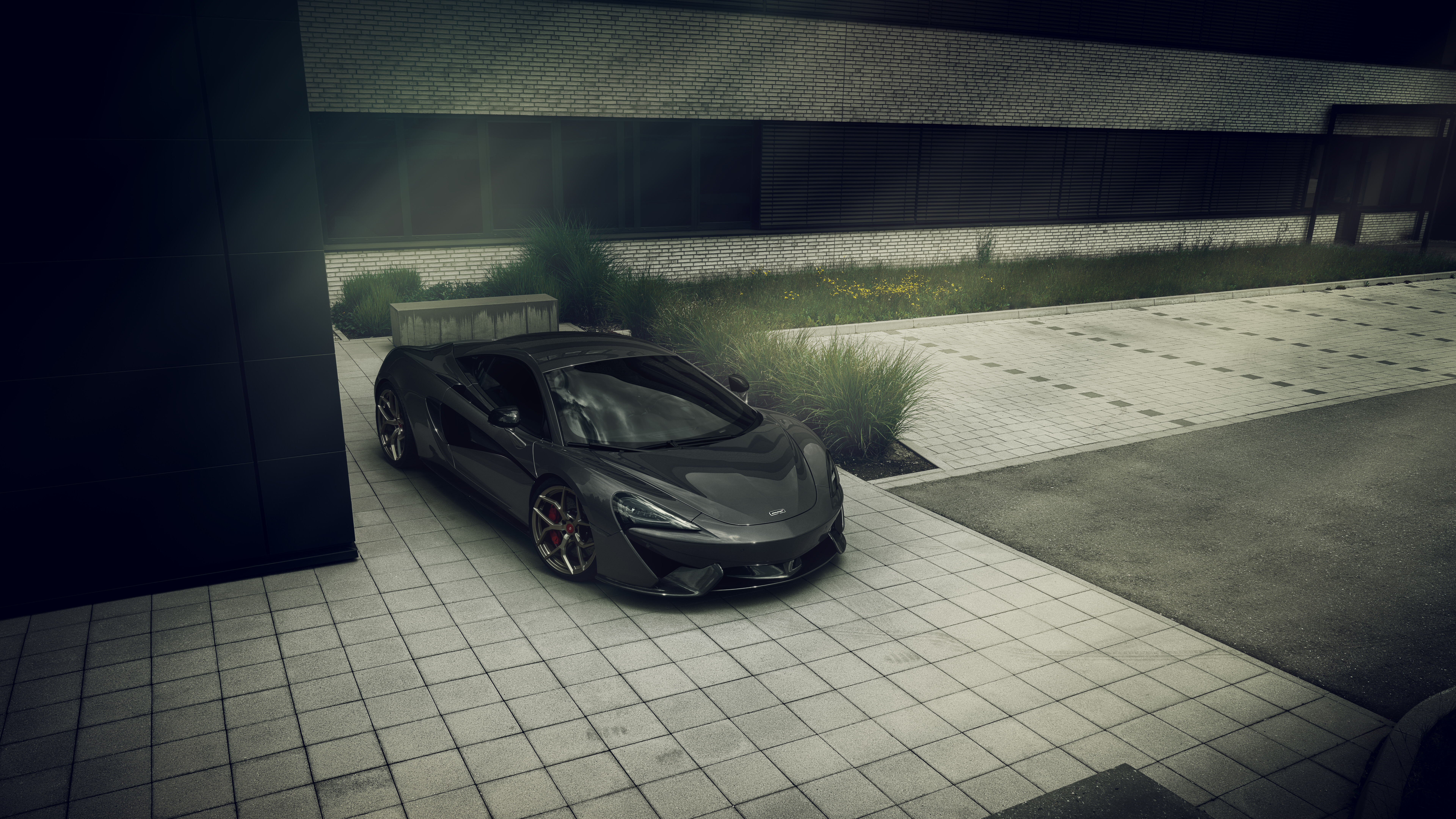 A glossy black McLaren 570S supercar showcasing its sleek aerodynamic body.