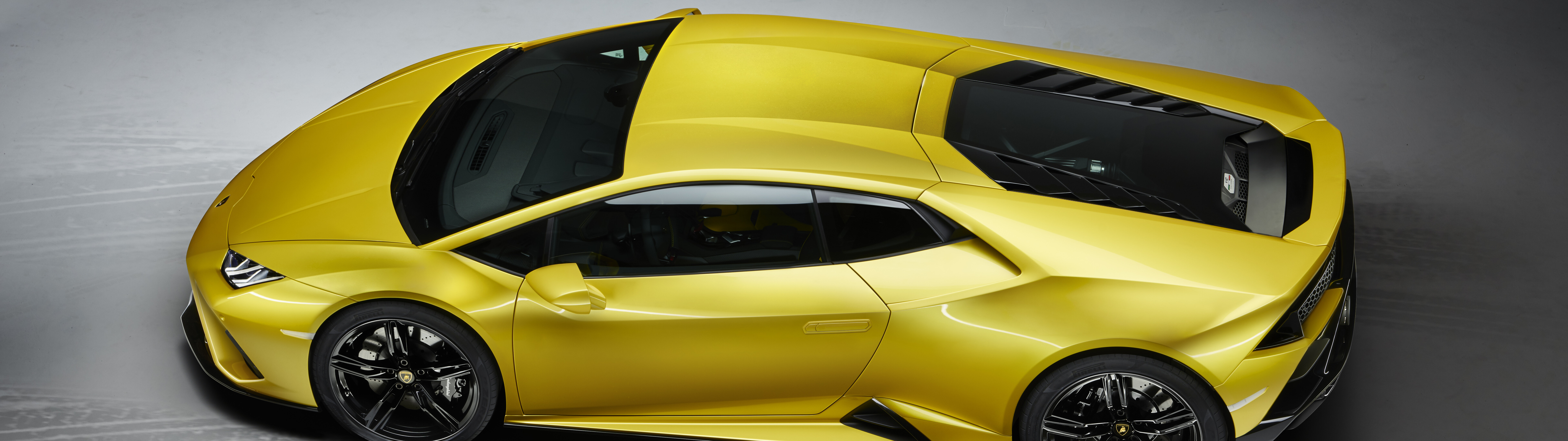 A vibrant yellow Lamborghini Huracan Evo supercar highlighting its sleek, aerodynamic body and bold design.
