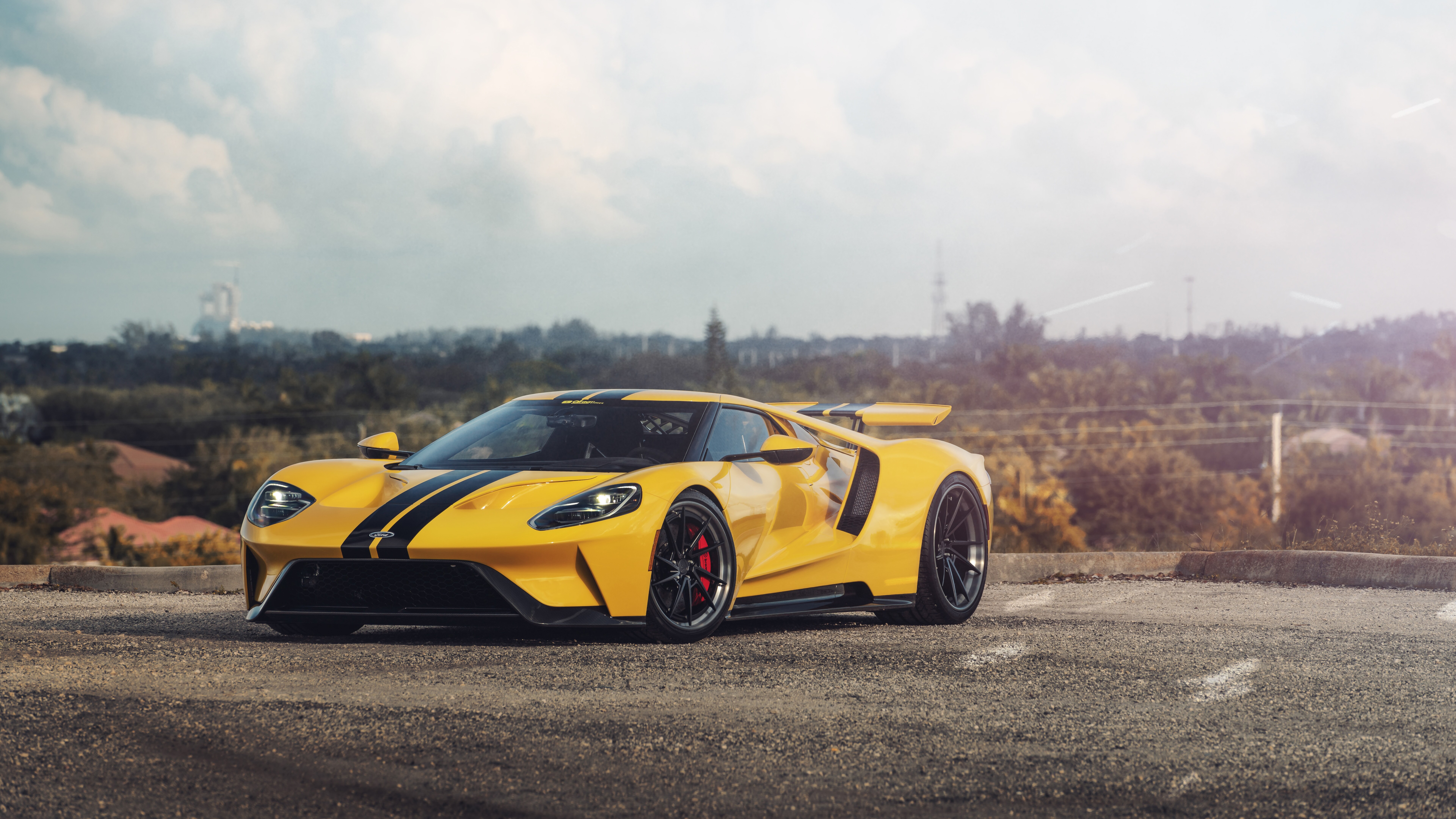A sleek and powerful yellow Ford GT supercar showcasing its aerodynamic design and bright color.