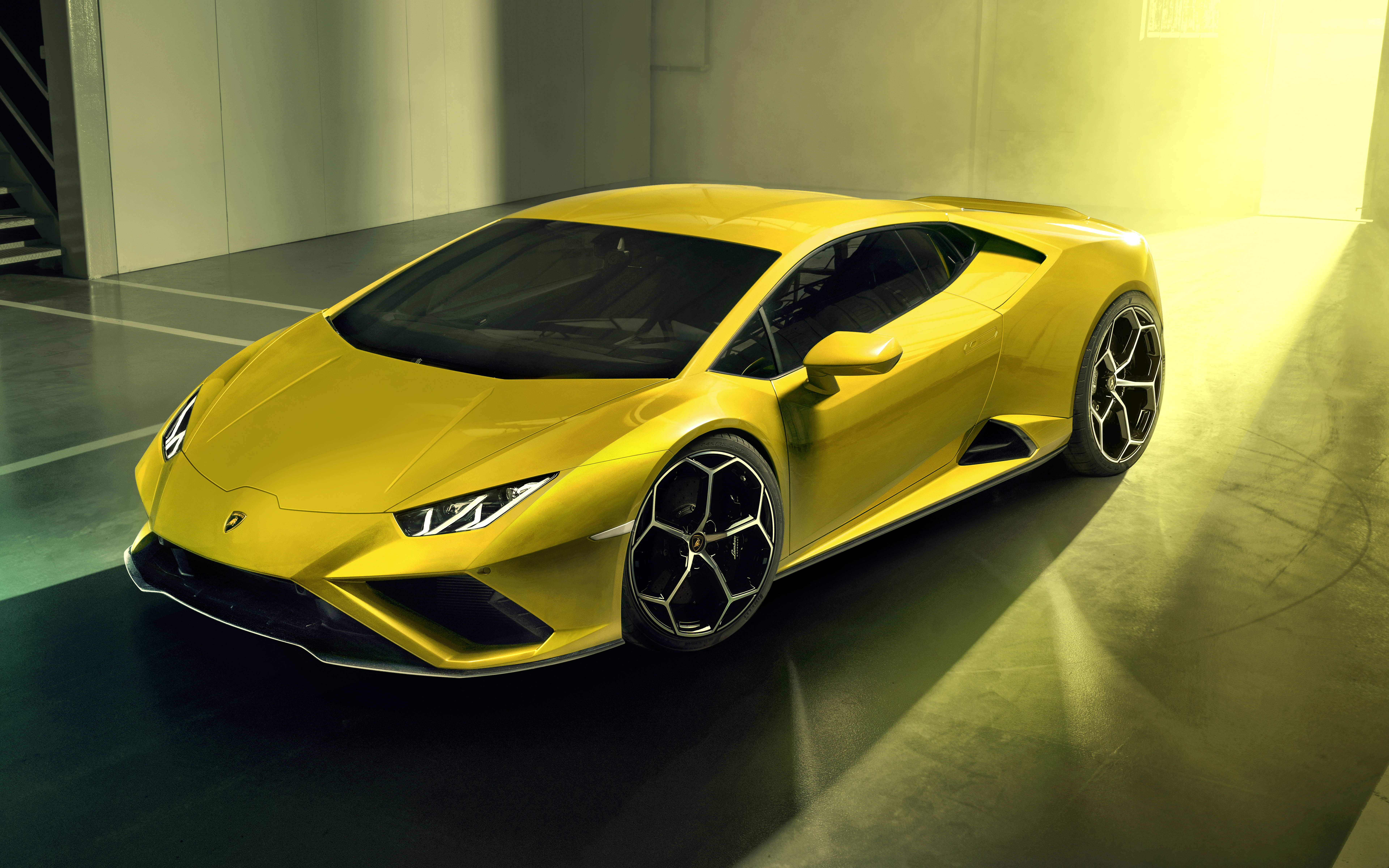 A bright yellow Lamborghini Huracan Evo supercar featuring sharp aerodynamic lines and iconic Italian design.