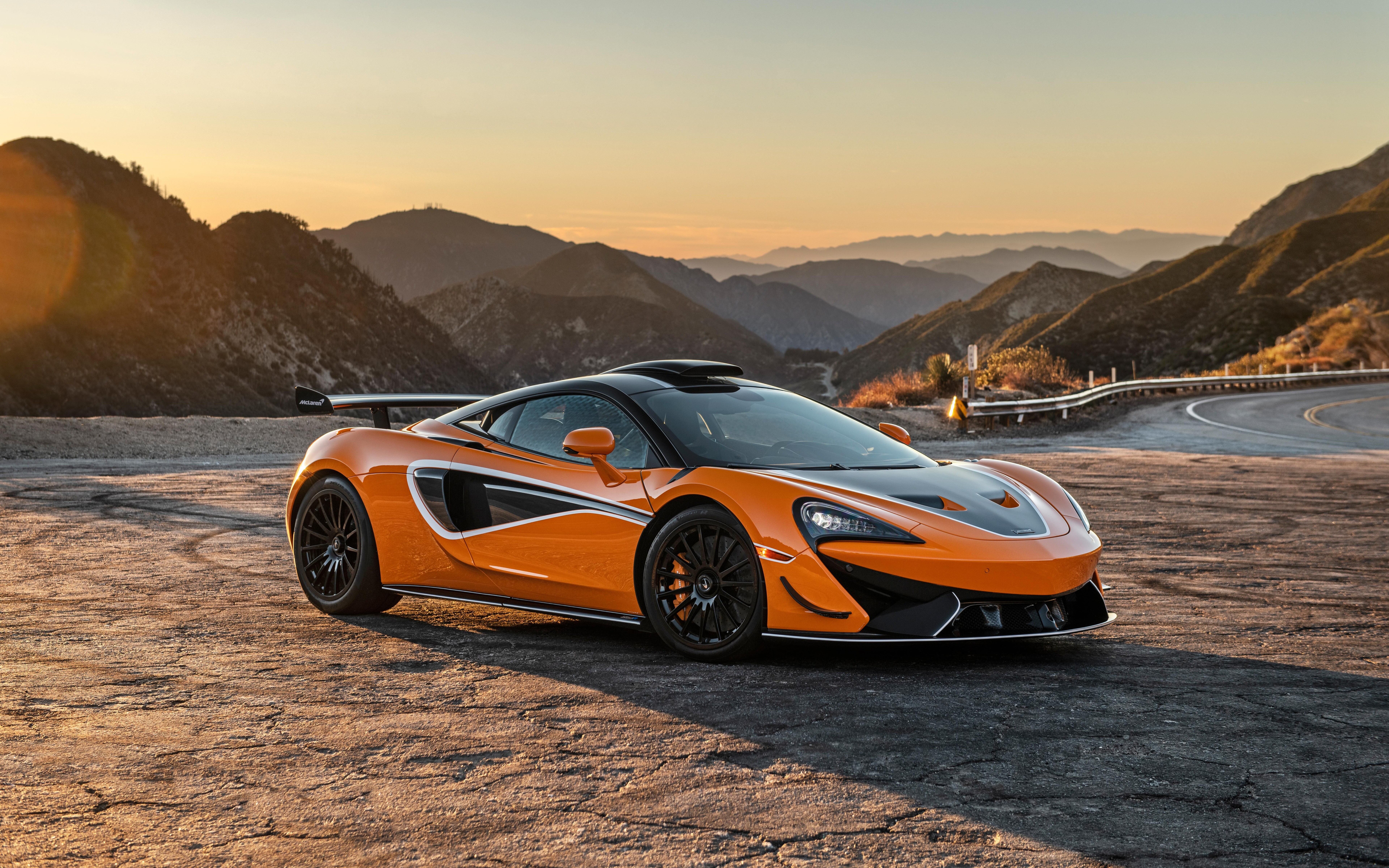 A vibrant orange McLaren 620R supercar featuring sleek aerodynamic lines and a high-performance design.