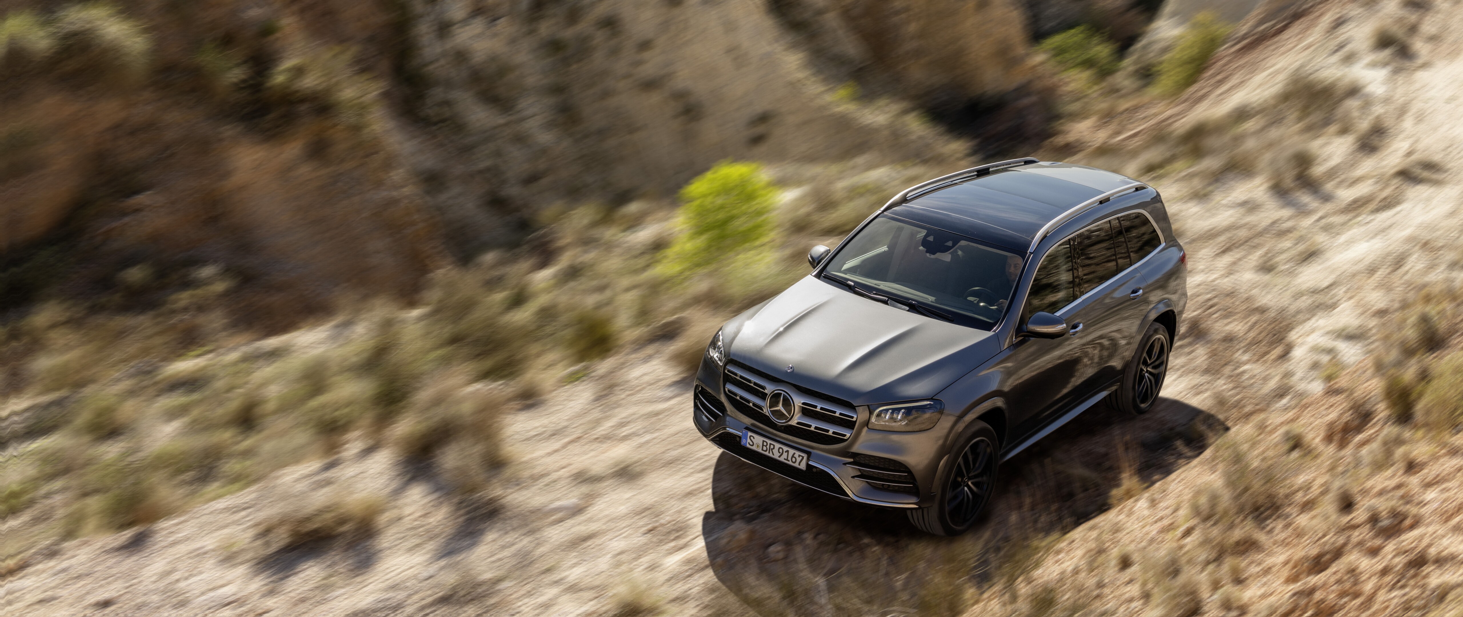 A high-quality view of a silver Mercedes-Benz GL-Class luxury SUV.