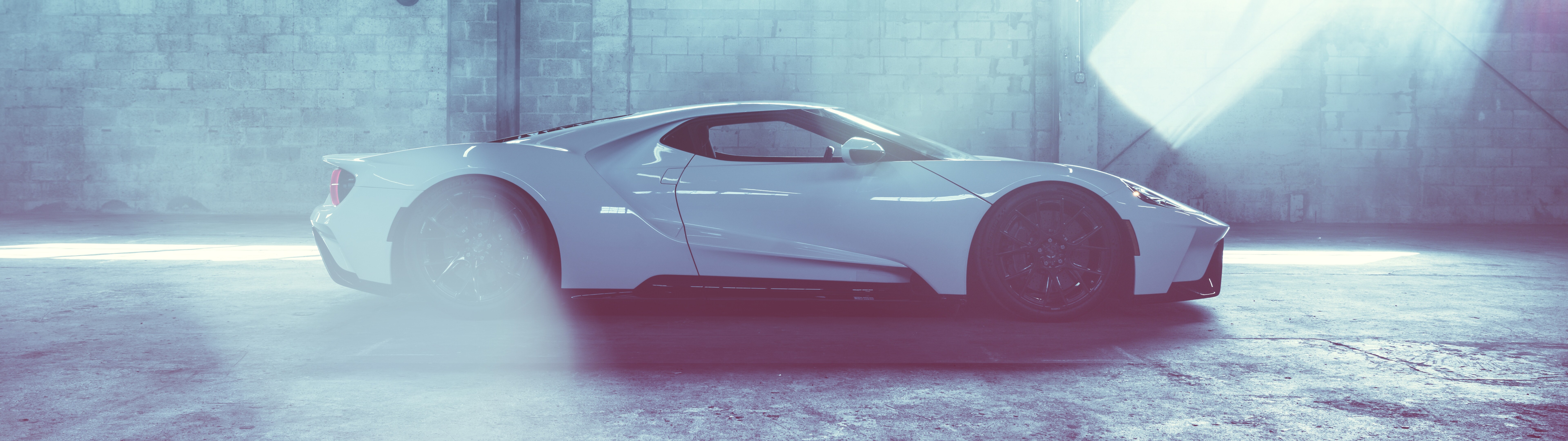 A high-performance white Ford GT supercar featuring a sleek, aerodynamic body and a brilliant white finish.