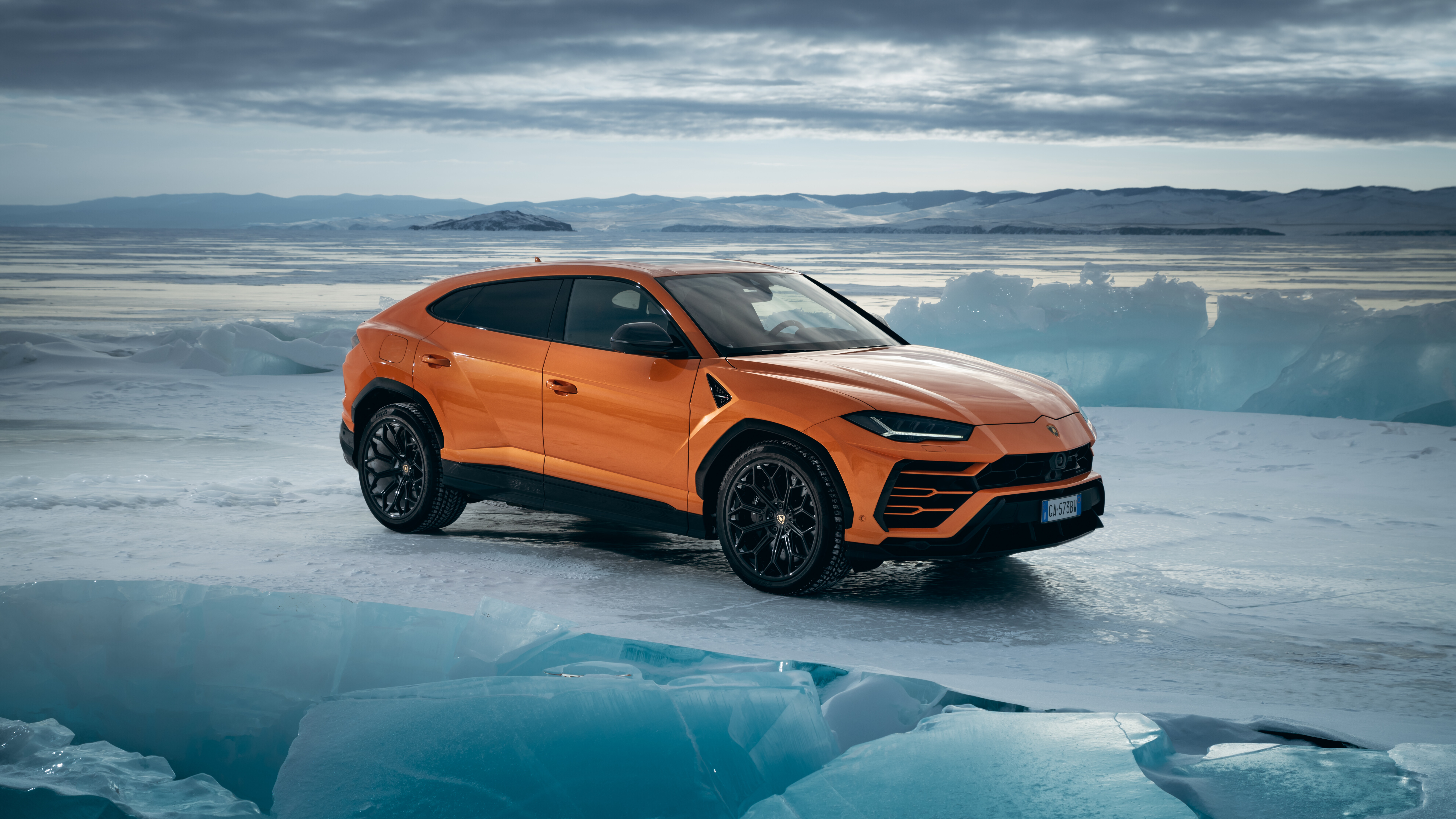A high-performance bright orange Lamborghini UrUS luxury SUV featuring aggressive styling and a sleek design.