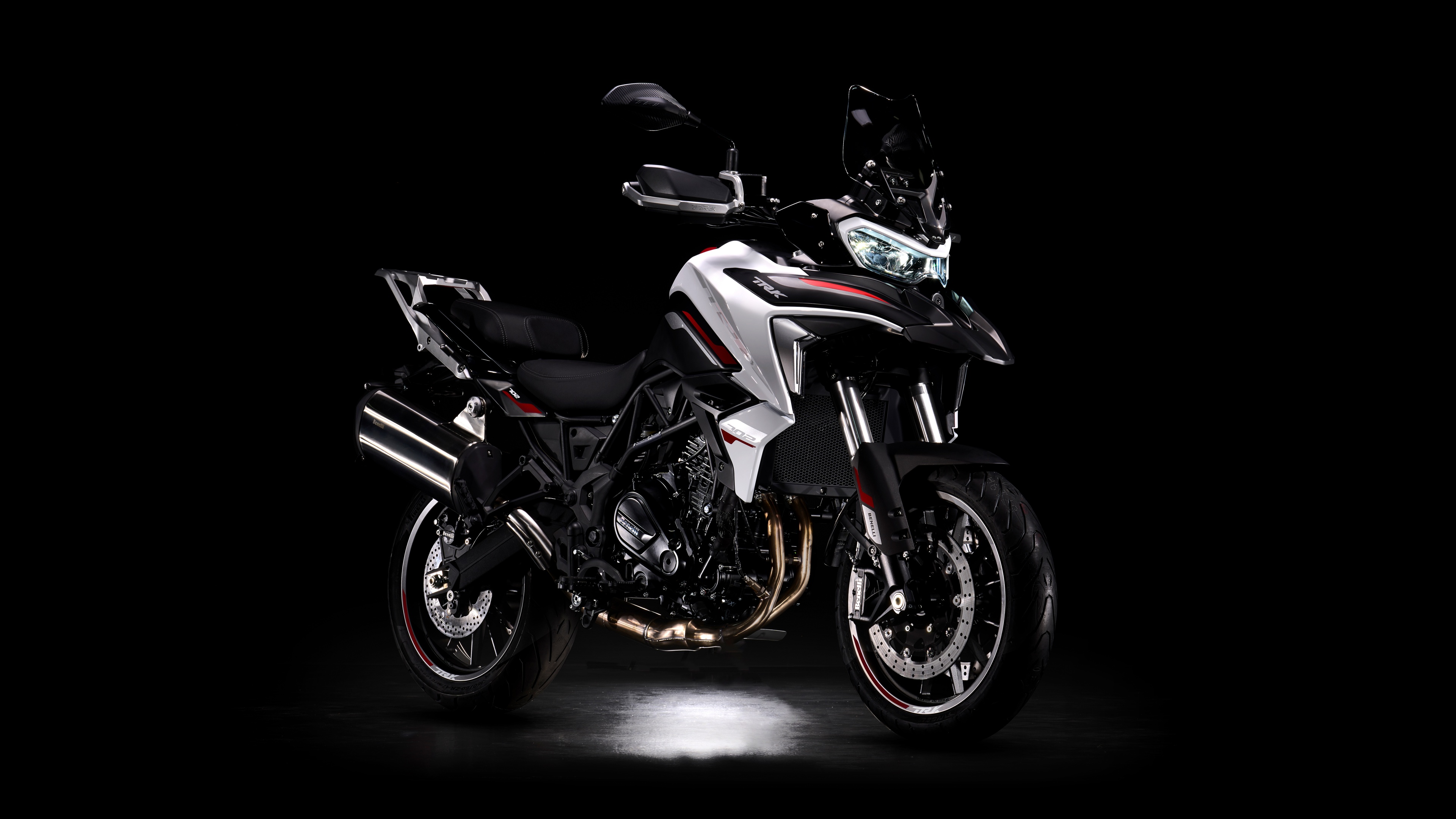 High-resolution view of 2024 adventure motorcycles on a black background.