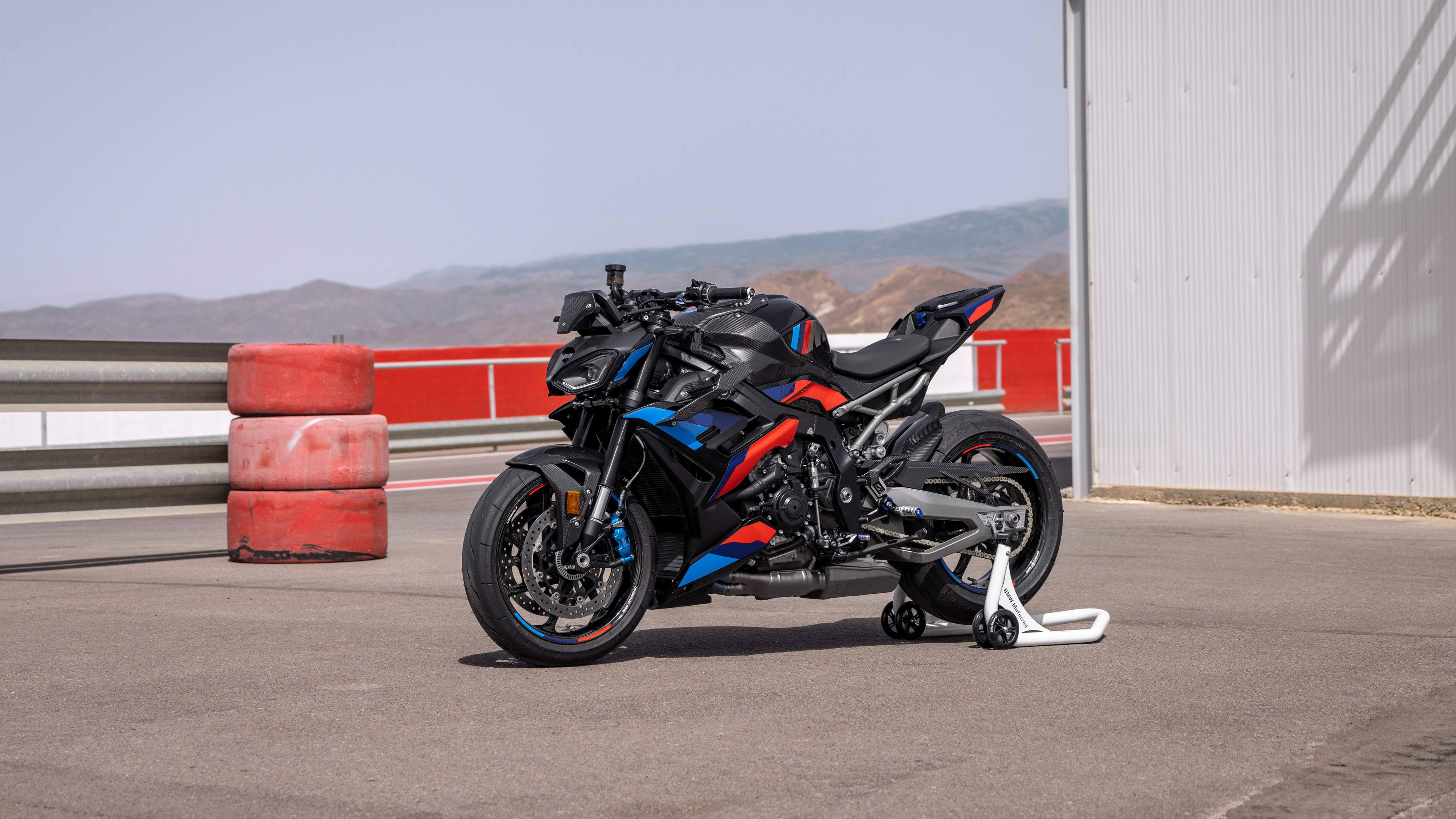 A high-resolution, detailed view of the 2024 BMW M 1000 R M Competition sports motorcycle featuring aggressive aerodynamic wings and M performance branding.