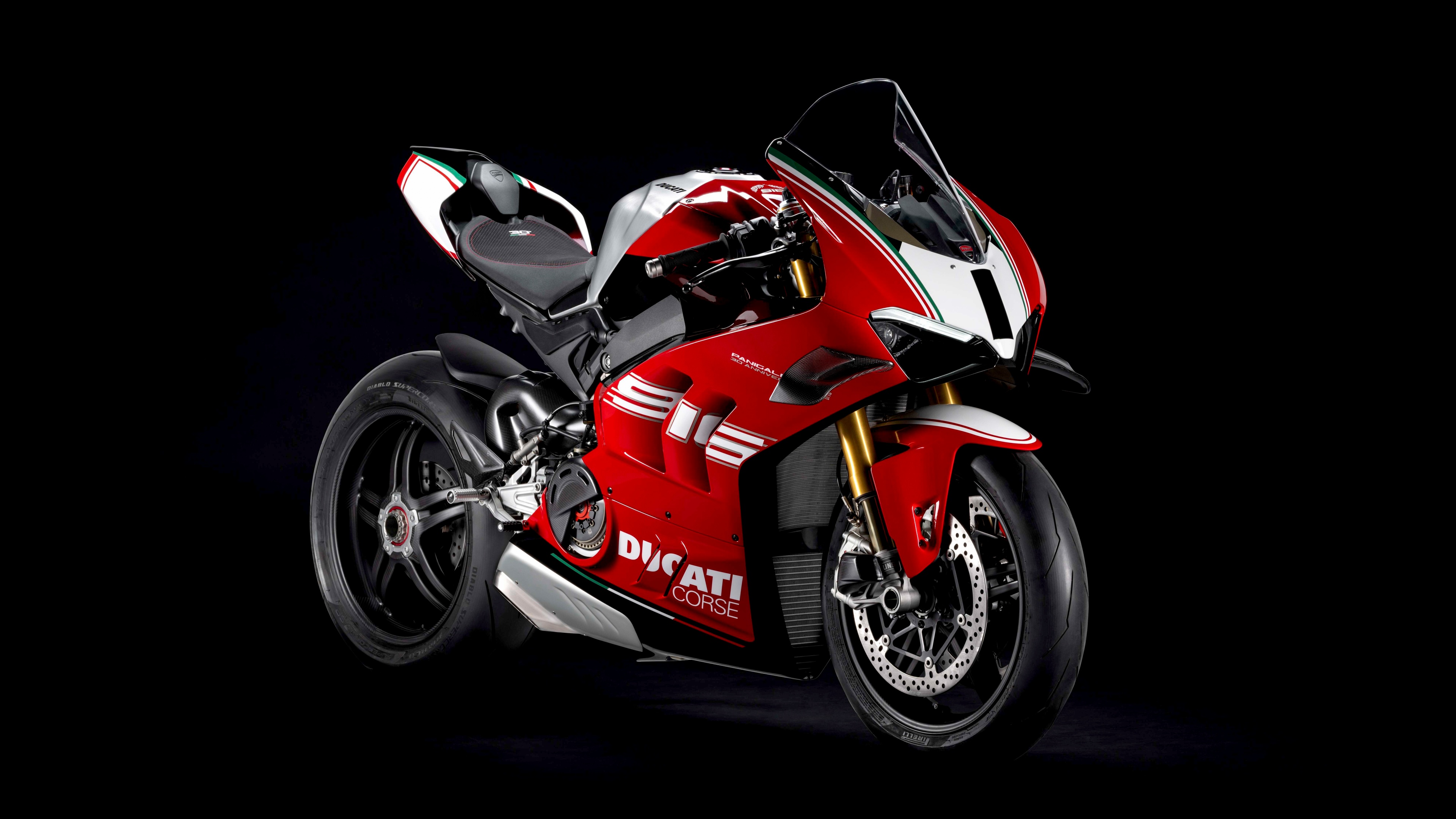 Close-up studio shot of the 2024 Ducati Panigale V4 SP2 Anniversary Edition motorcycle against a black background.