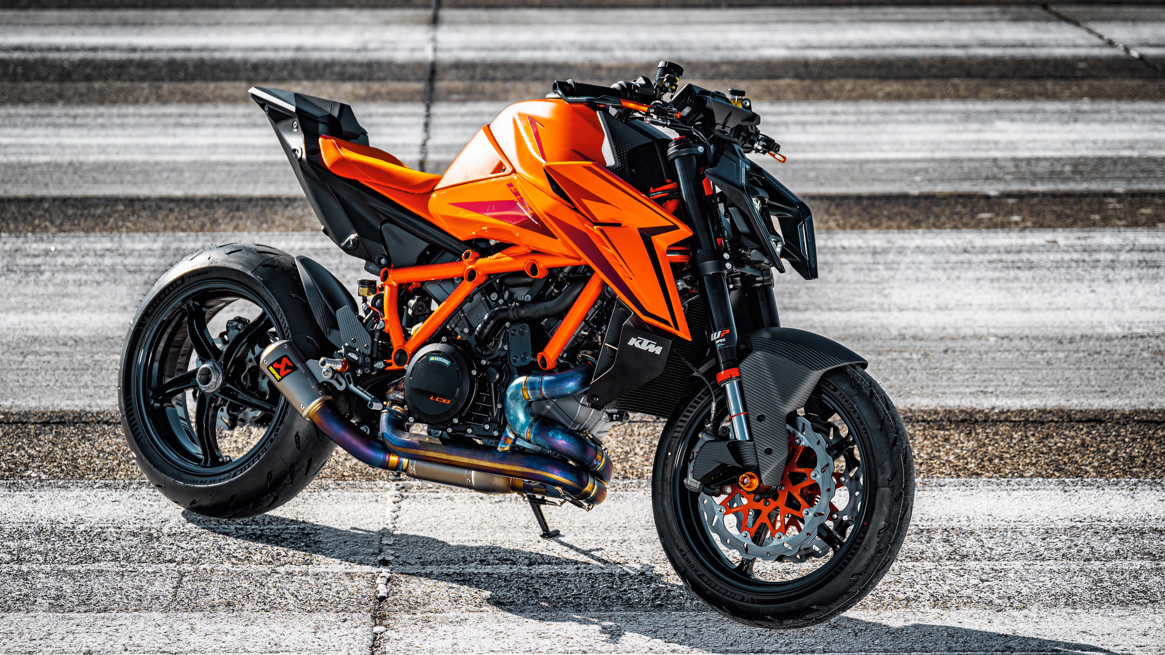 A high-detail view of the 2024 KTM 1390 Super Duke R naked motorcycle featuring aggressive styling and sharp aerodynamic lines.
