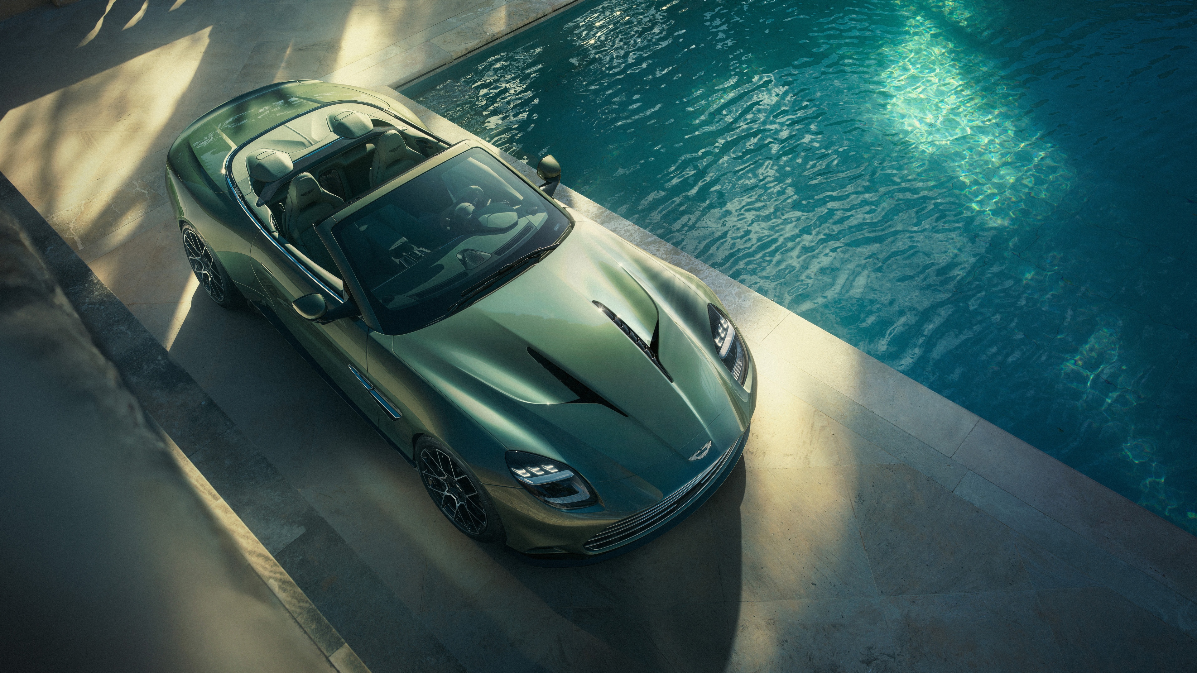 A cinematic, high-resolution close-up of the 2025 Aston Martin Vanquish Volante luxury convertible.