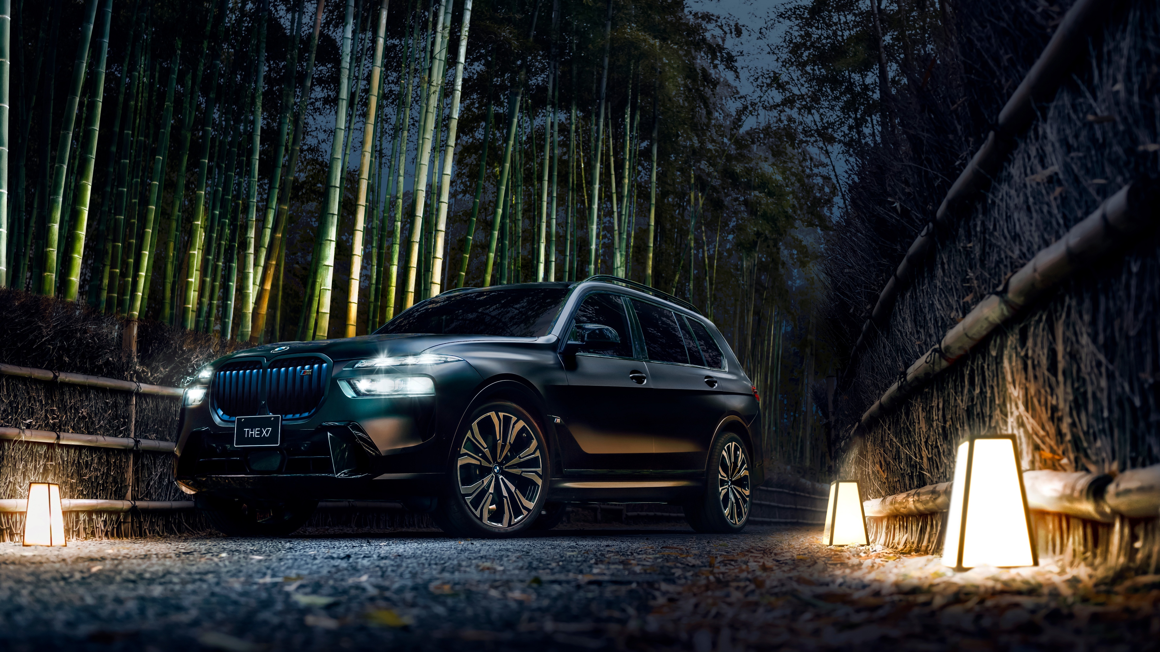 A high-resolution, cinematic shot of a black 2025 BMW X7 luxury SUV in a dark, moody setting.
