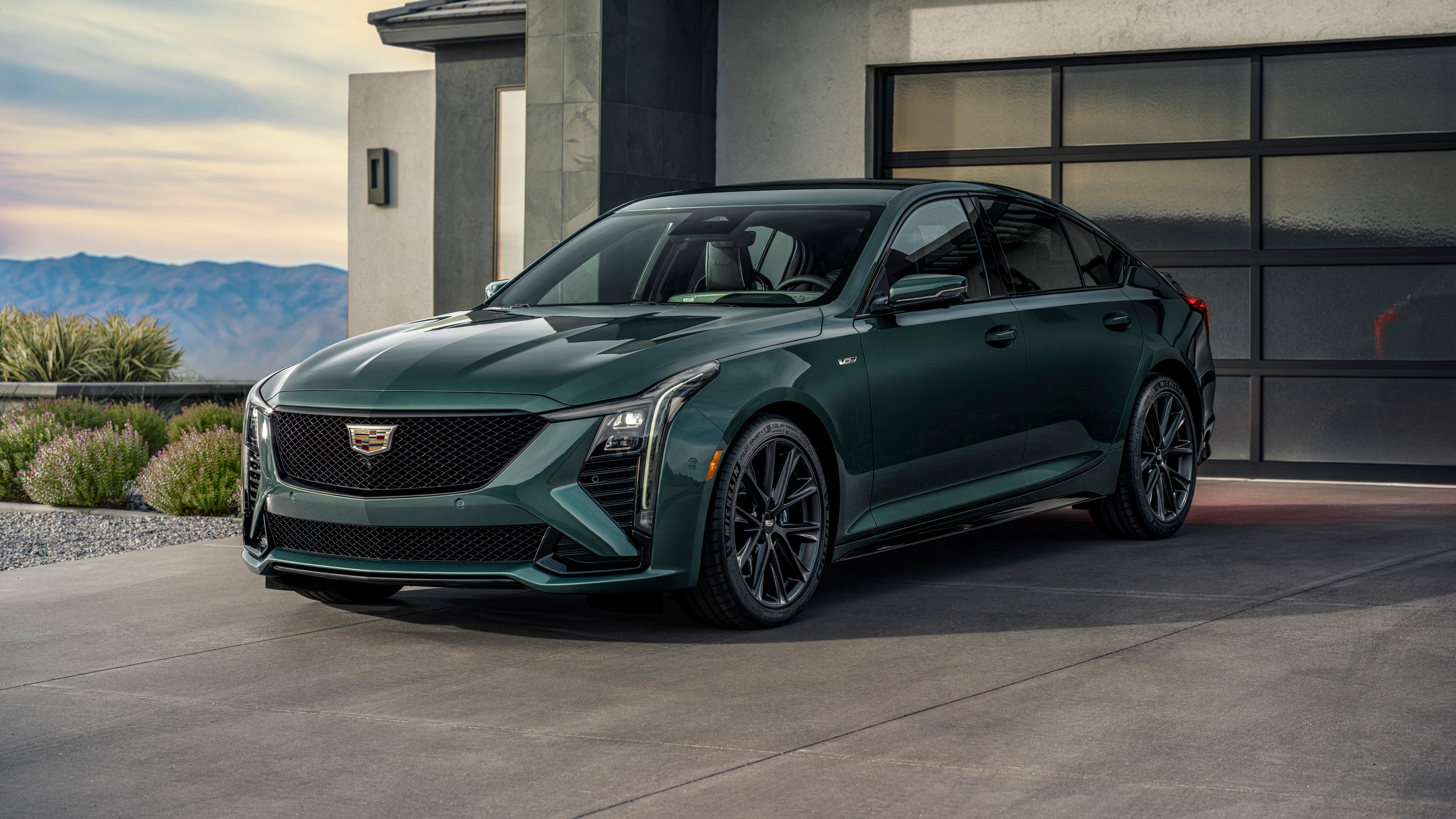 A high-resolution, cinematic view of a 2025 Cadillac CT5-V luxury sedan with a sleek metallic body and aggressive design.
