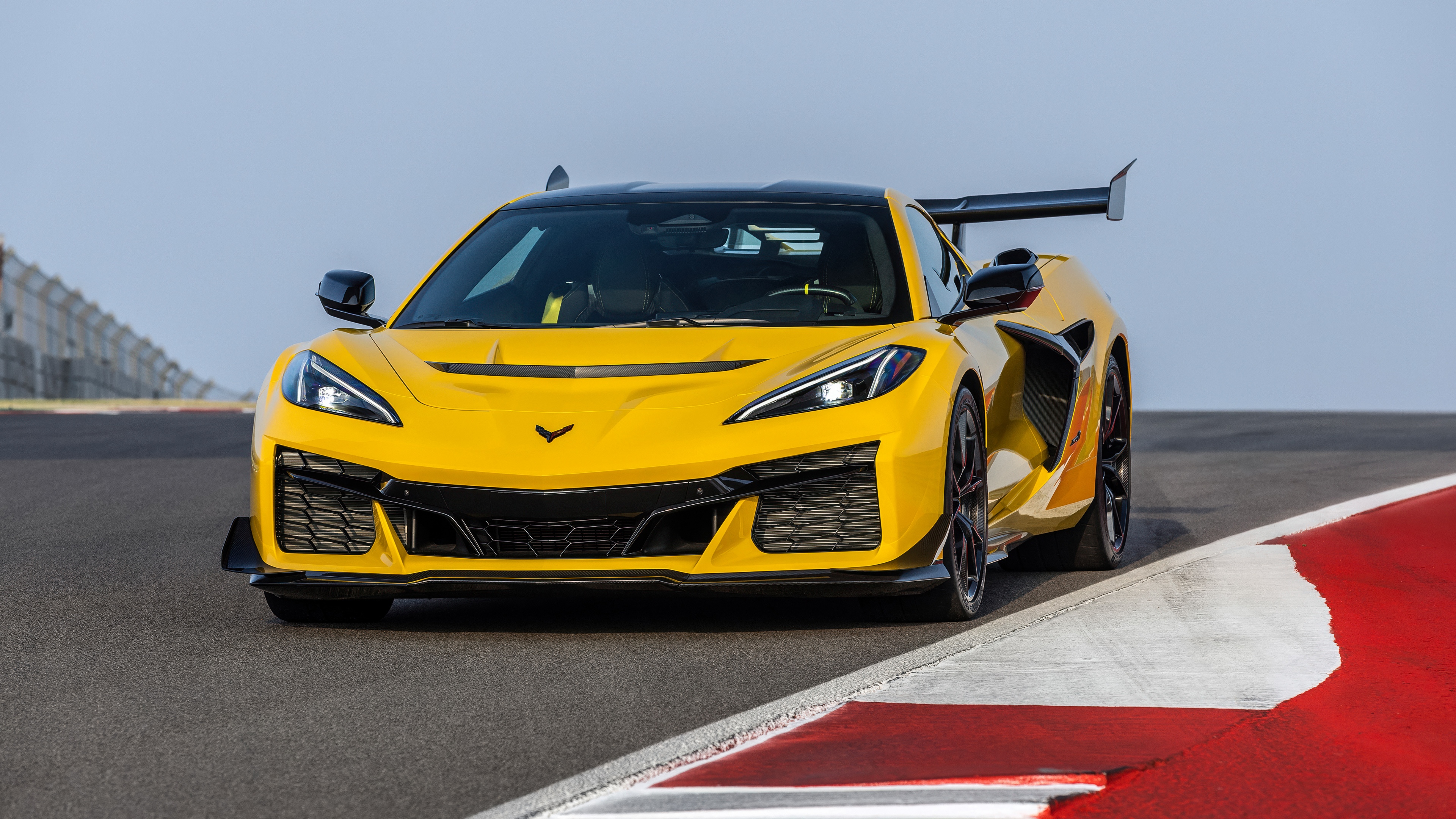 A high-performance 2025 Chevrolet Corvette ZR1 sports car driving on a professional racing circuit.