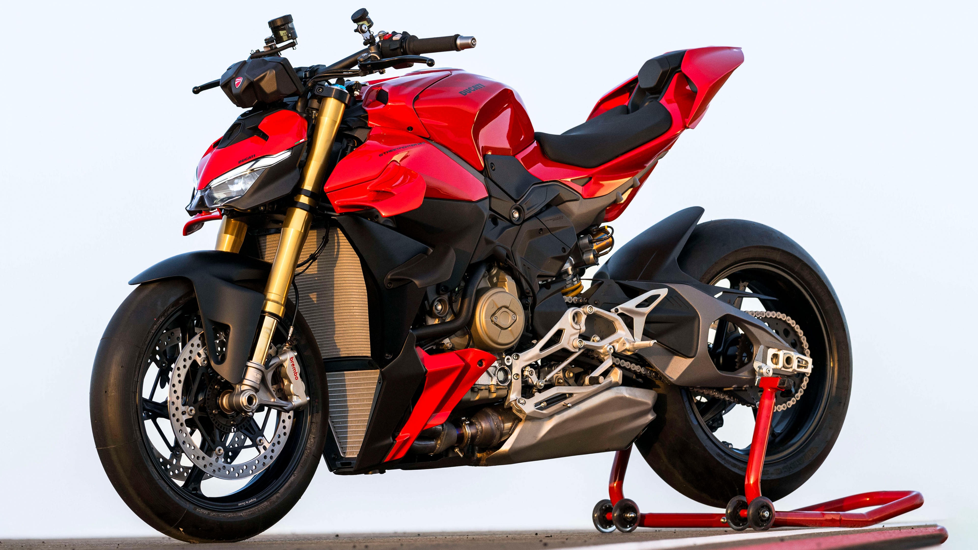 A professional-grade 5K photograph of a bright red 2025 Ducati Streetfighter V4 motorcycle.