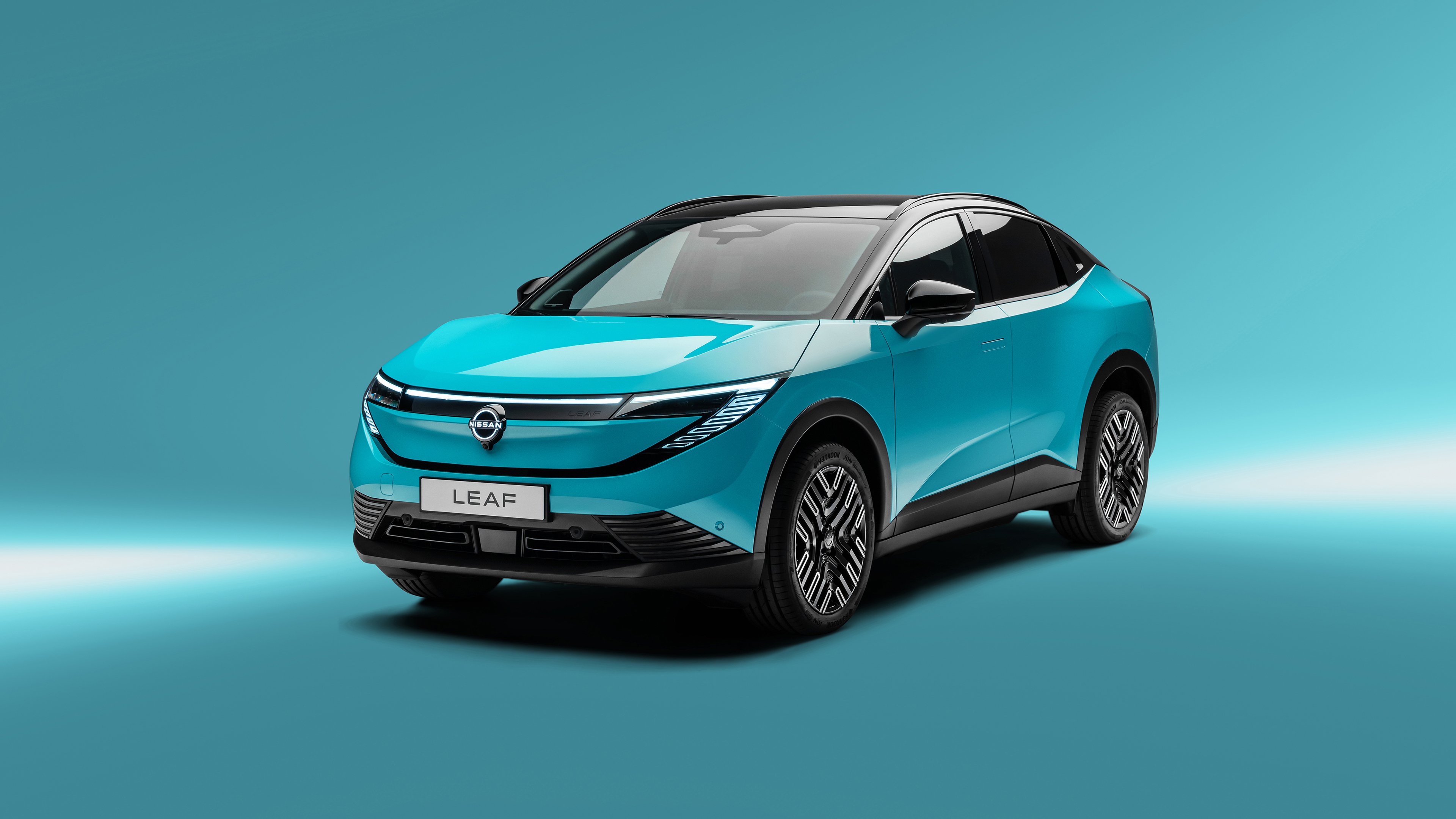 A futuristic 2025 electric crossover SUV displayed against a solid, bright turquoise background.