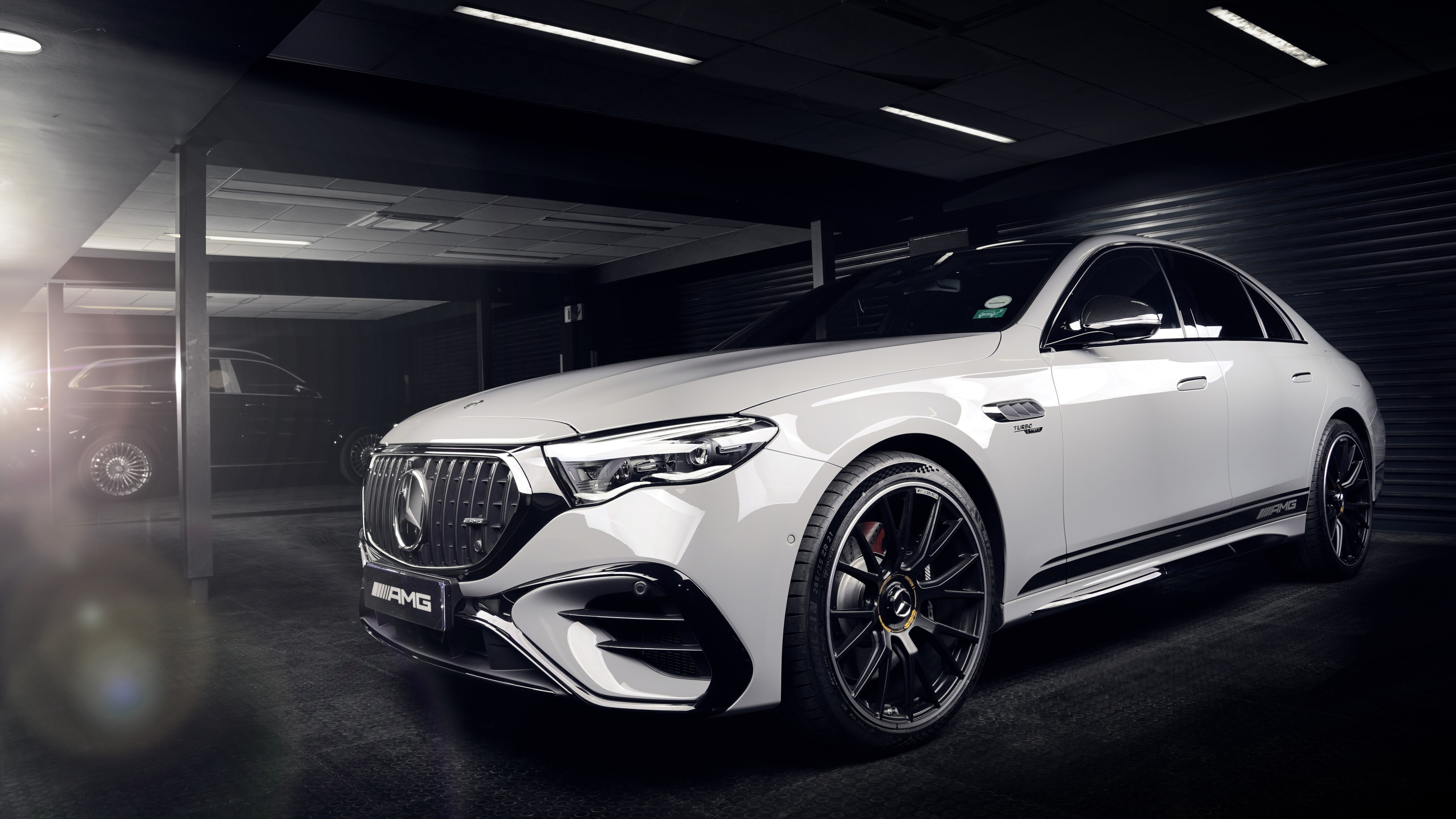 A high-resolution, dark aesthetic shot of a 2025 Mercedes-AMG E 53 HYBRID 4MATIC+ Edition 1 luxury sedan.
