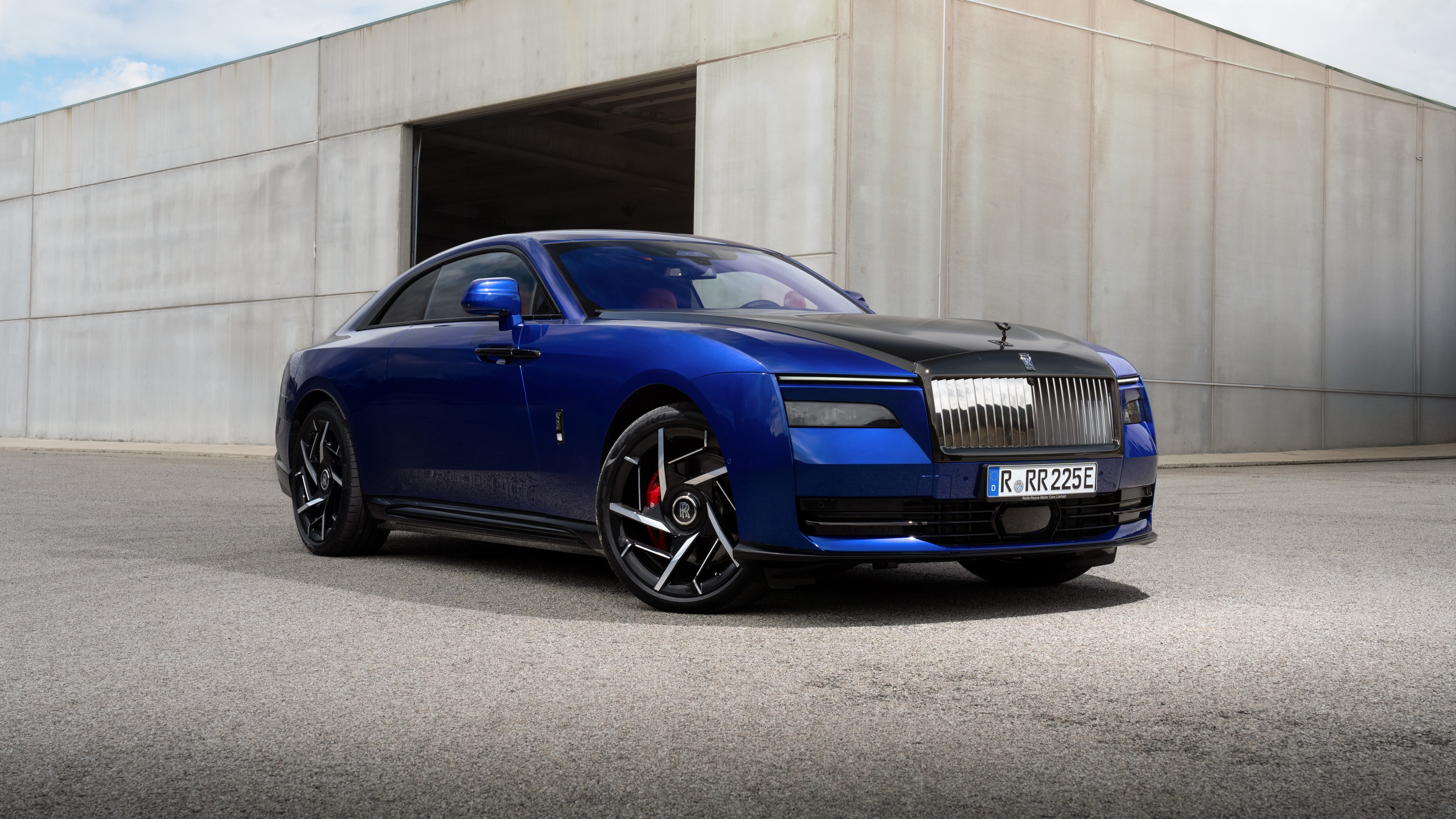 A high-resolution, detailed view of the 2025 Rolls-Royce Black Badge Spectre luxury electric coupe featuring a deep, lustrous black finish.
