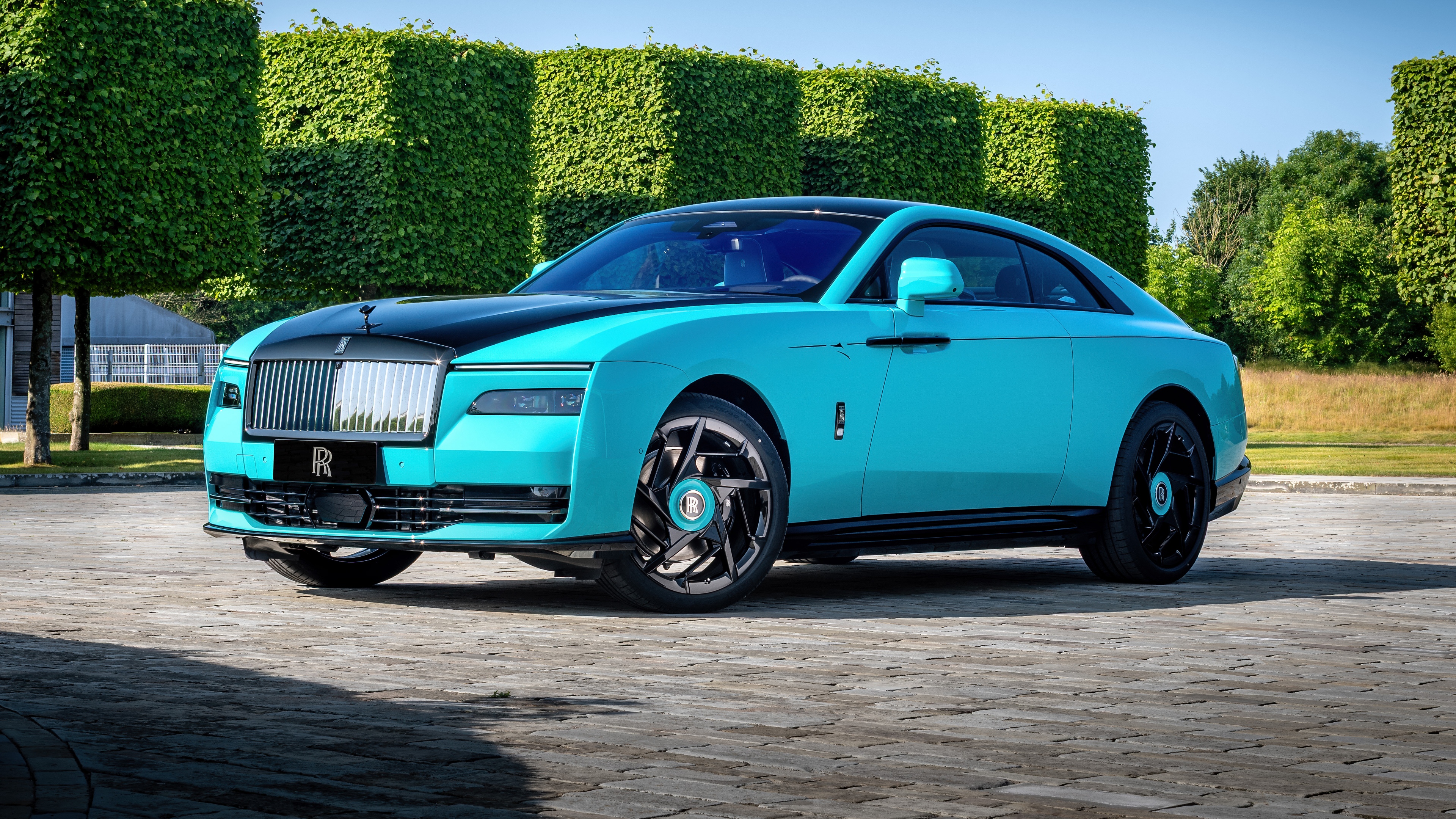 A high-detail, 5K perspective of the 2025 Rolls-Royce Black Badge Spectre luxury electric vehicle.
