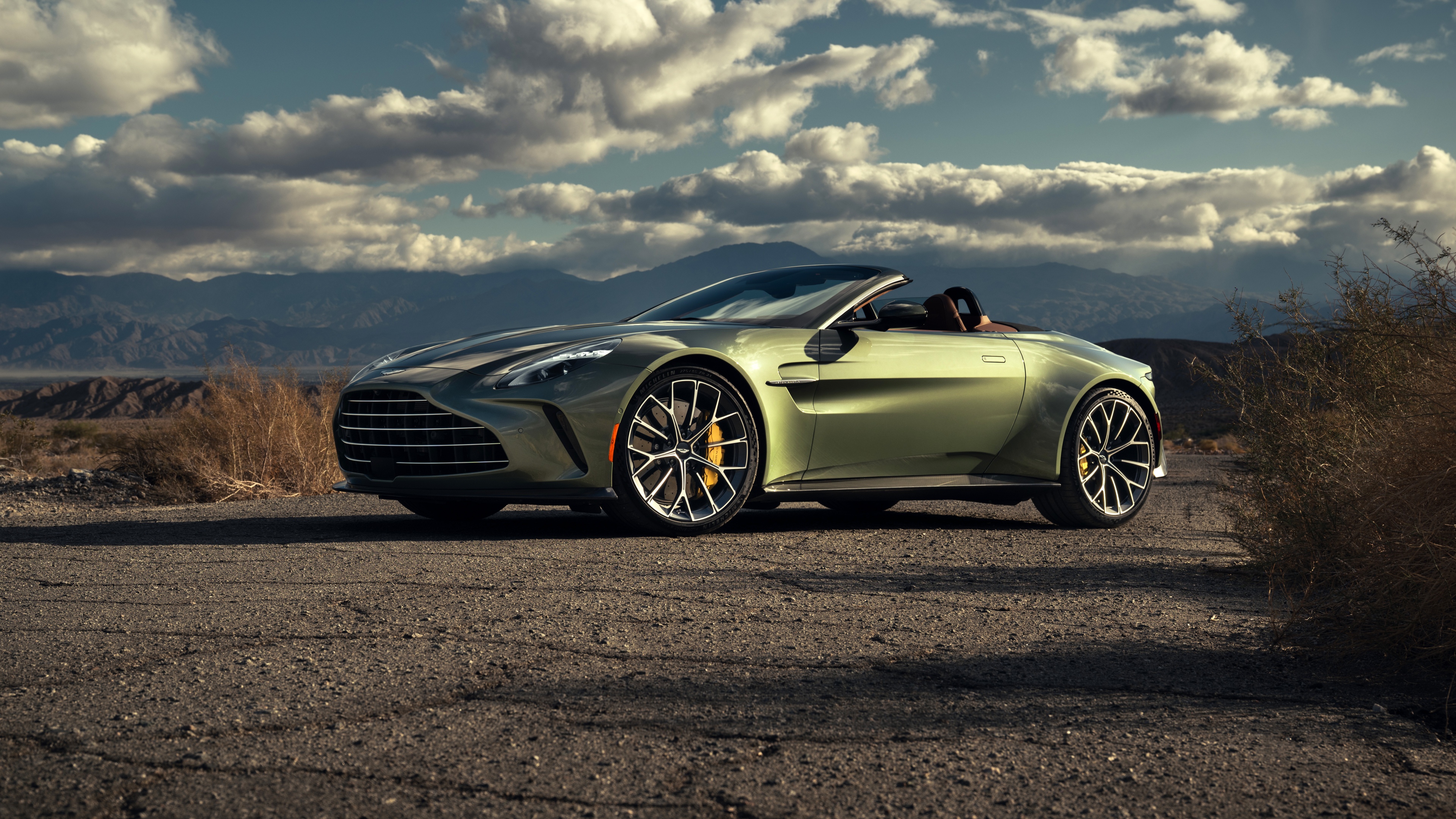 A sleek 2026 Aston Martin Vantage Roadster convertible in a high-detail cinematic shot.