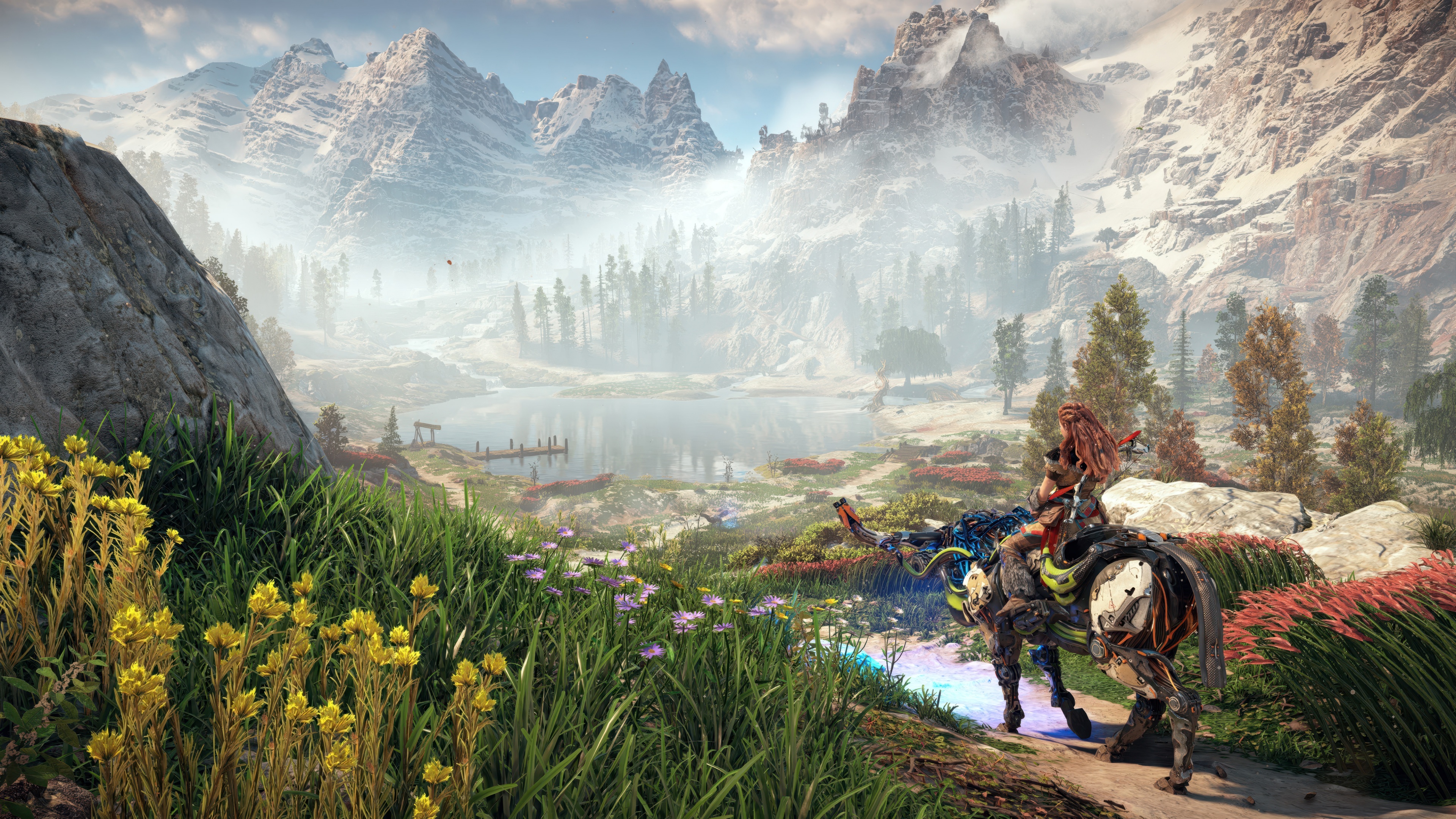 Aloy from the game Horizon Zero Dawn standing amidst a vast, beautiful landscape.