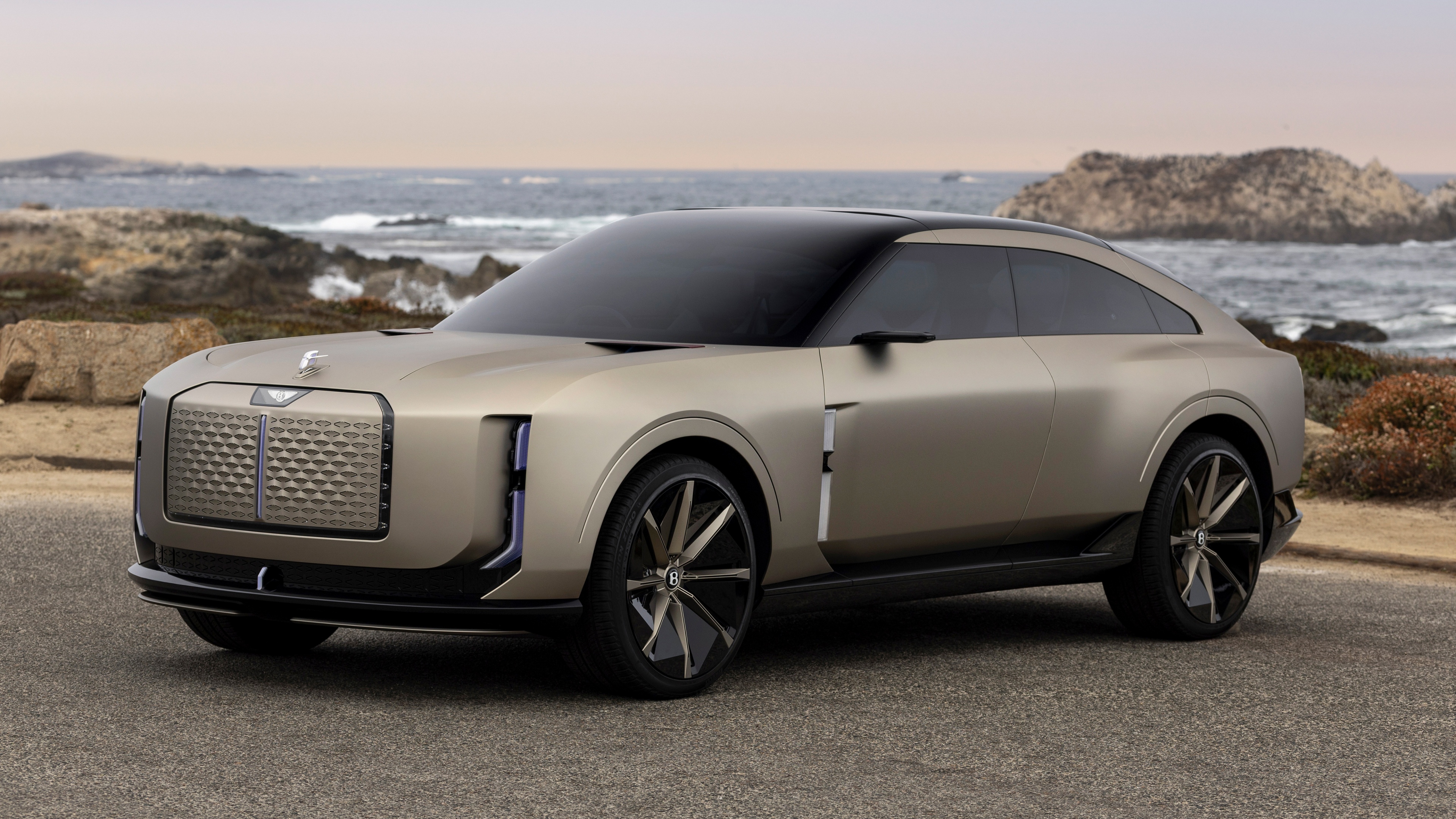A sleek and aerodynamic Bentley EXP 15,5K concept car featuring futuristic lighting and a metallic finish.