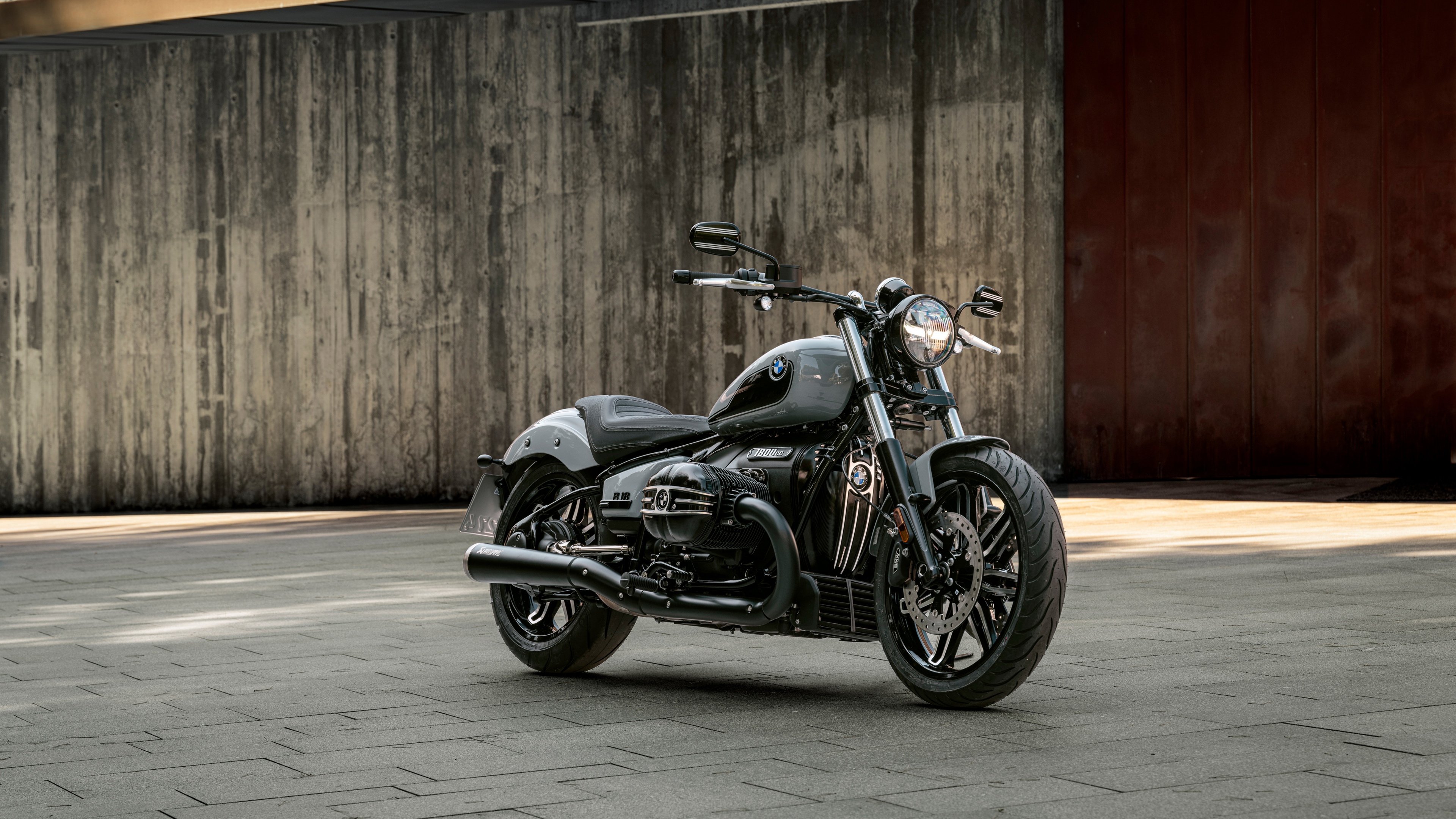 A high-detail, cinematic shot of a 2025 BMW R 18 classic style cruiser motorcycle featuring chrome and metallic accents.