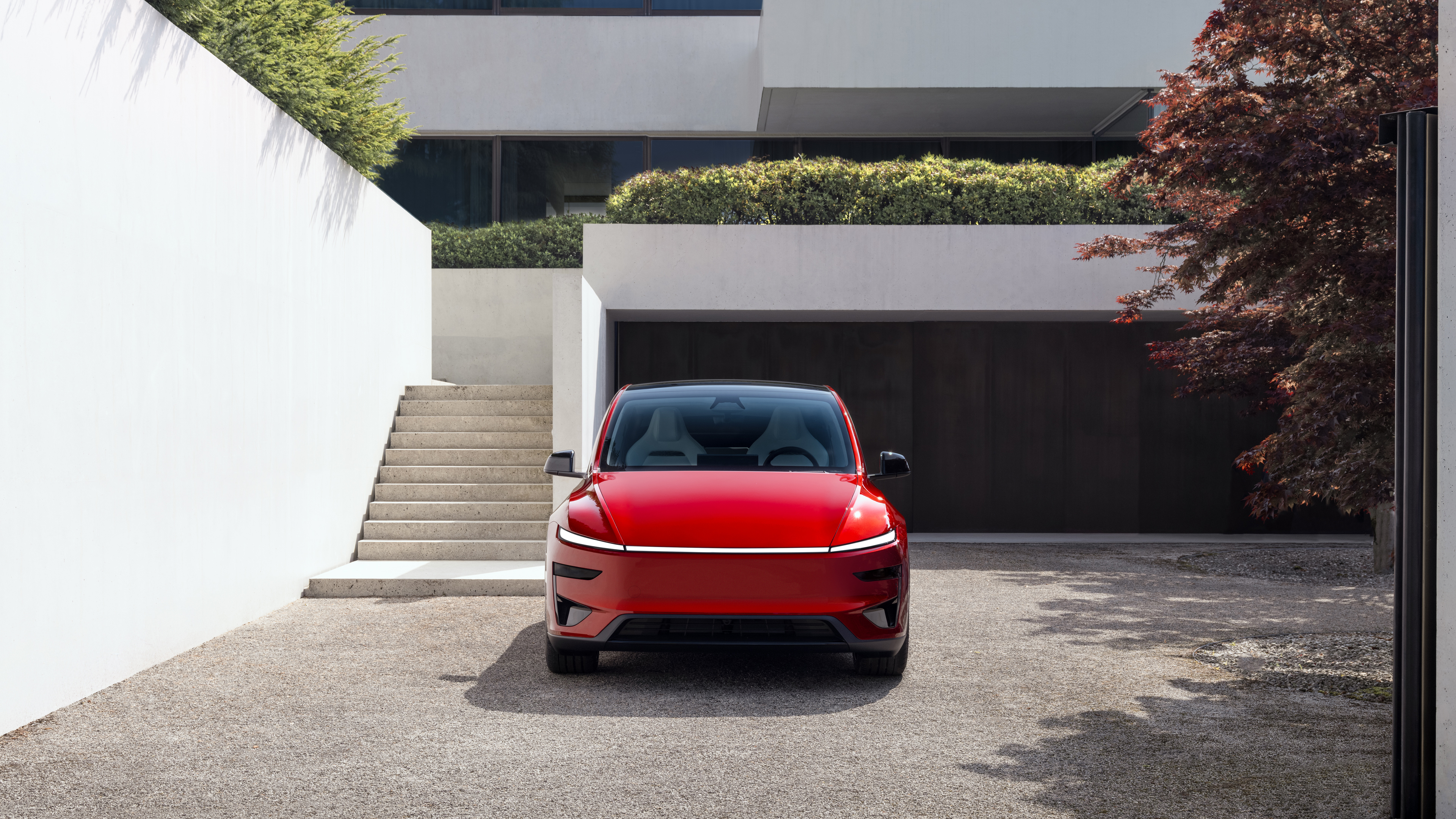 A collection of vibrant red futuristic concept cars with sleek, aerodynamic bodies and modern metallic finishes.