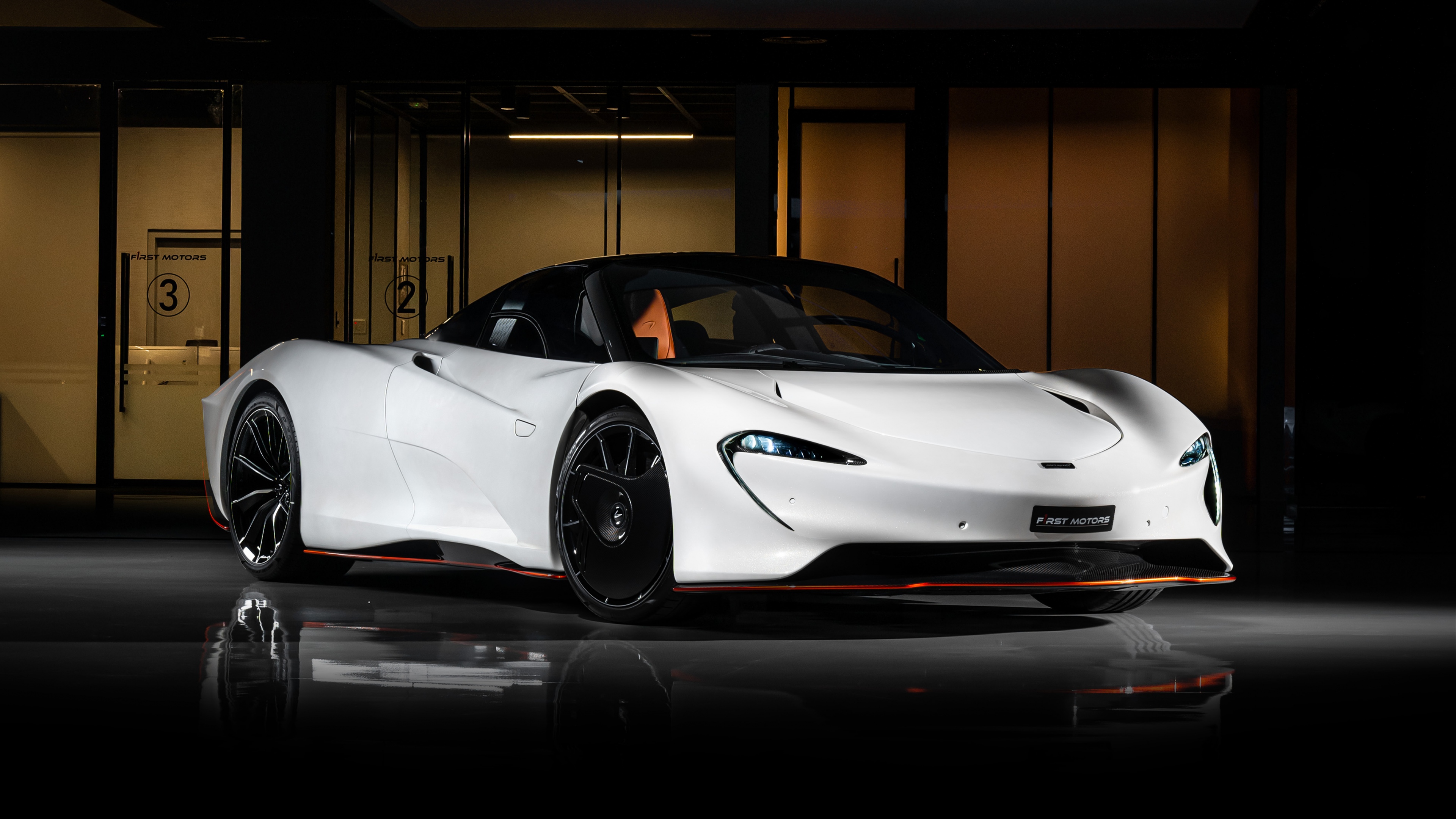 A sleek white McLaren Speedtail hypercar captured in a vertical composition, highlighting its aerodynamic curves.