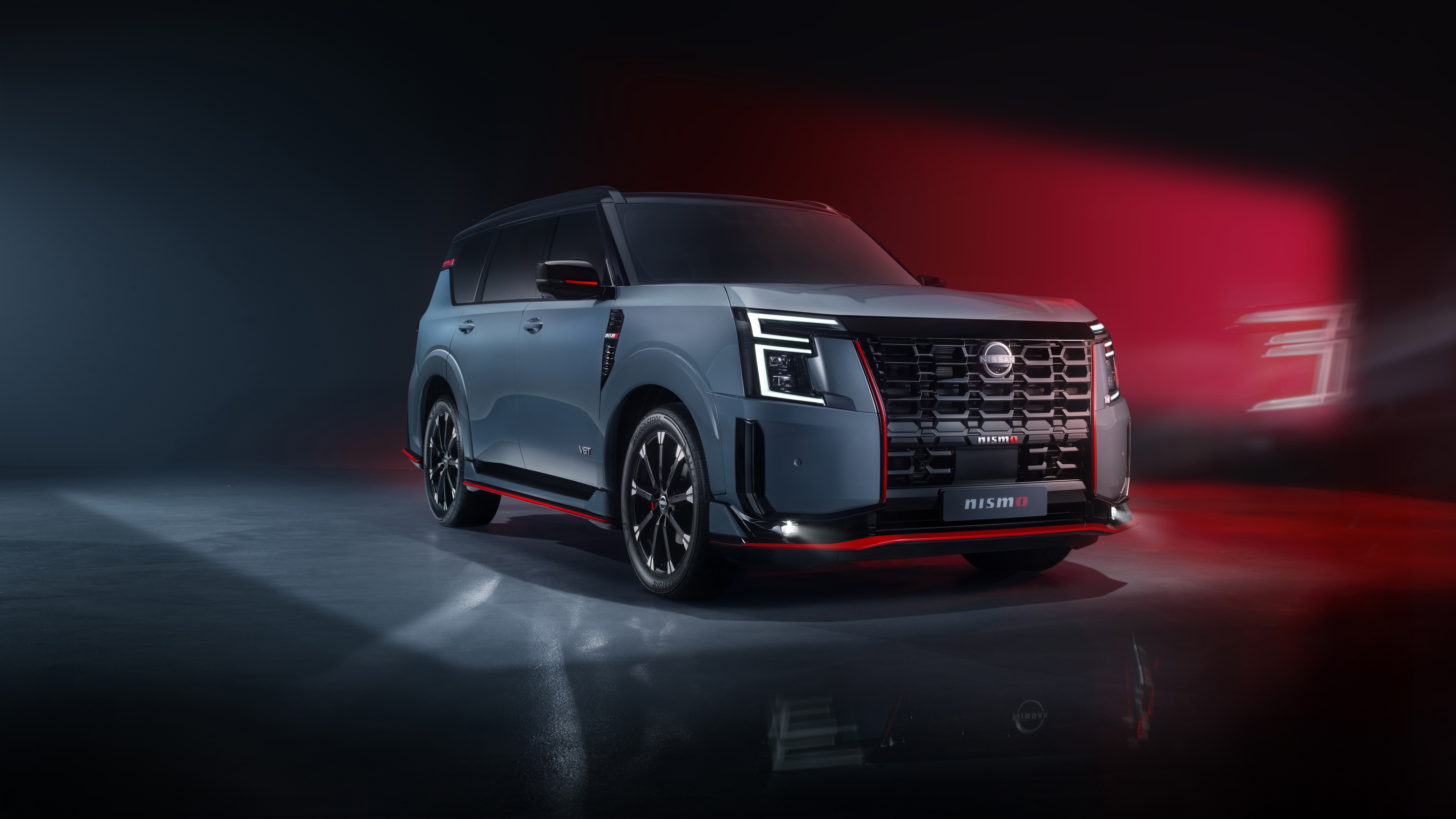 A metallic 2025 performance SUV driving on a futuristic city road at night with bright neon lights.
