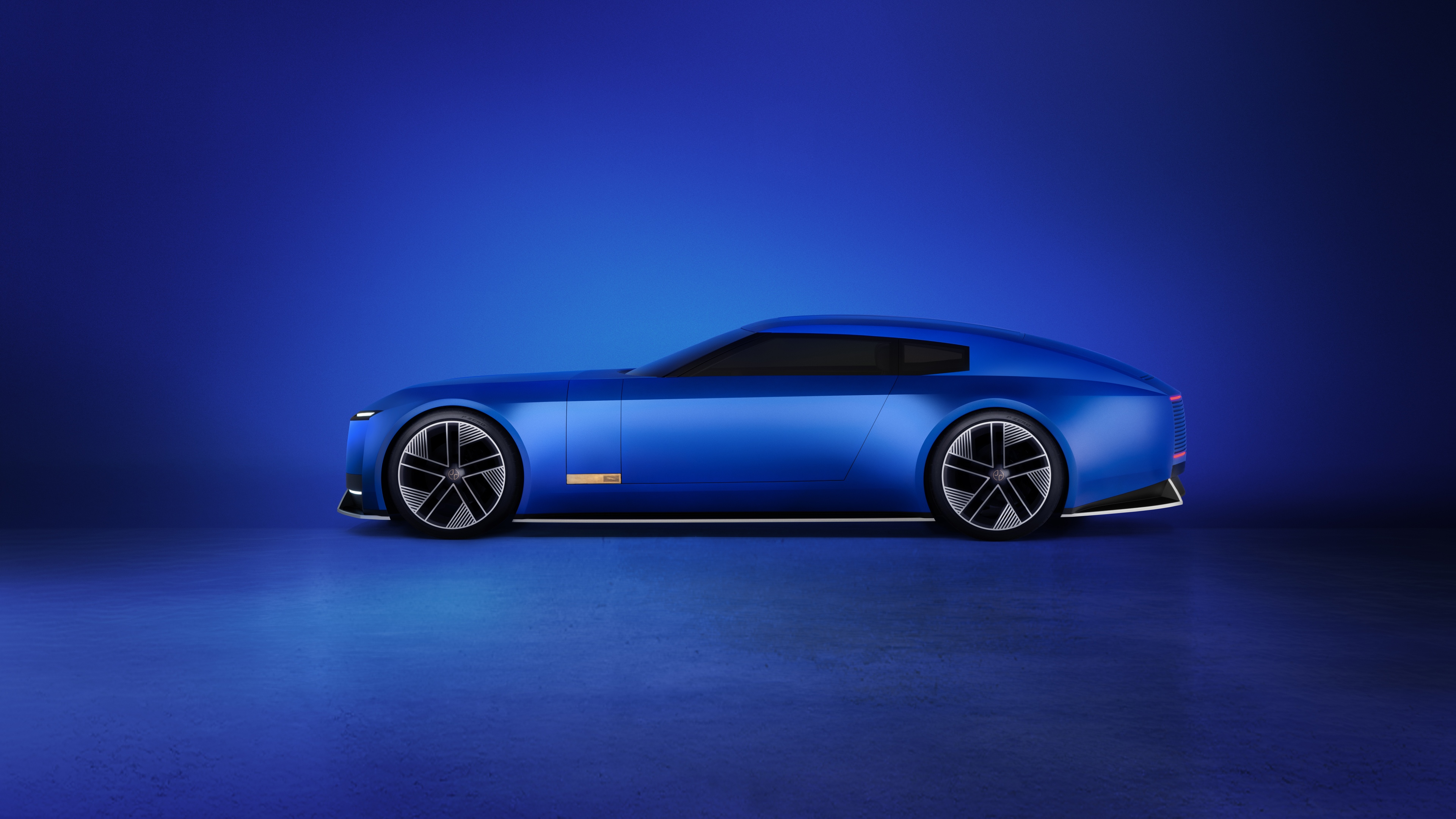 A sleek, monochromatic blue Jaguar Type 00 concept car in a deep French Ultramarine shade.