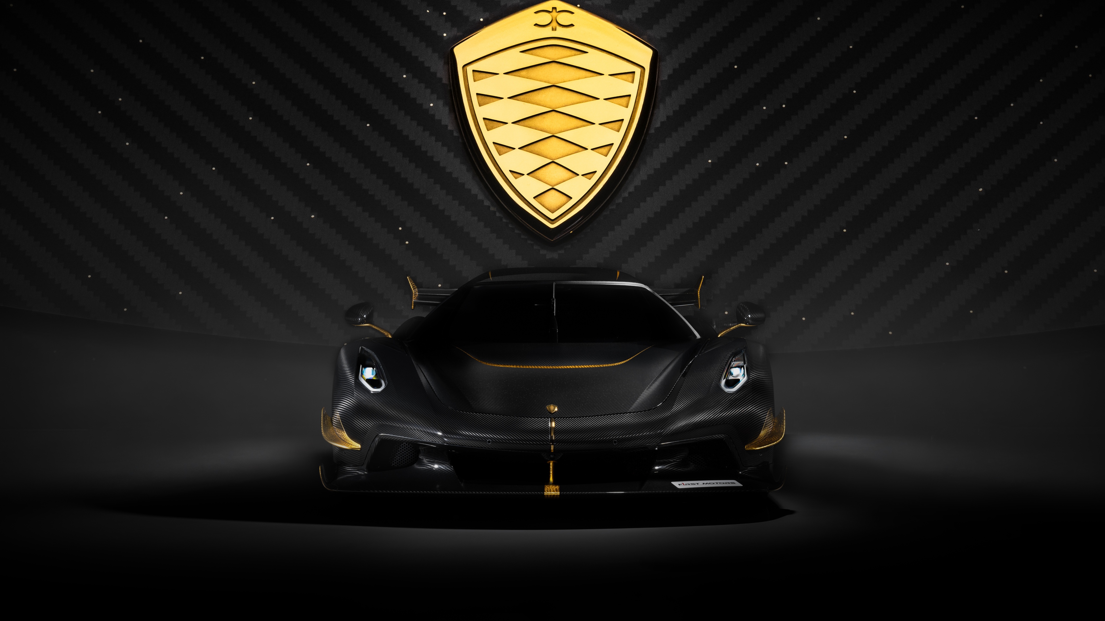 A dark, hyper-realistic view of a Koenigsegg Jesko hypercar with visible carbon fiber textures against a black background.