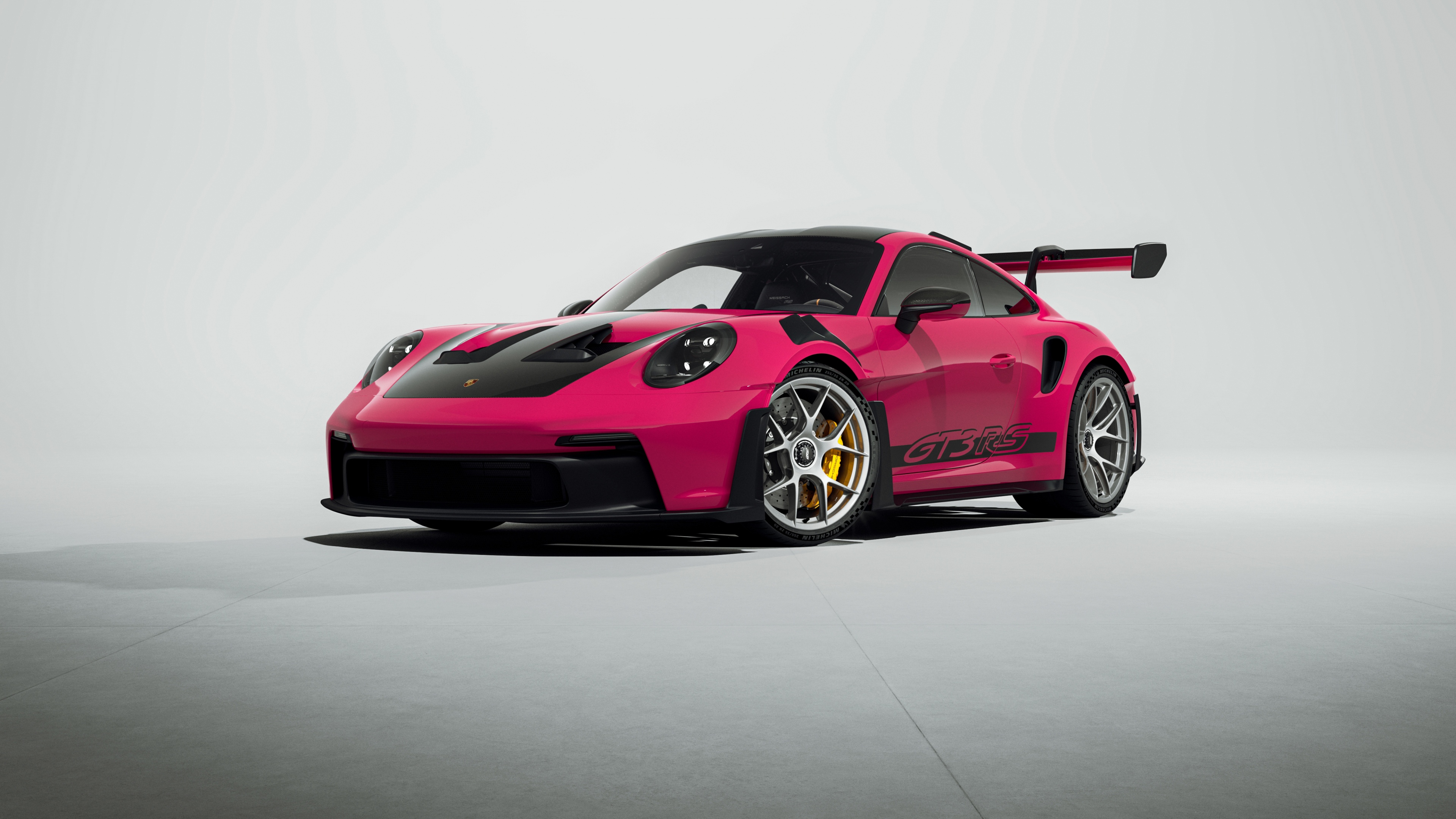 A vibrant pink Porsche 911 GT3 RS sports car in high-resolution 5K detail.