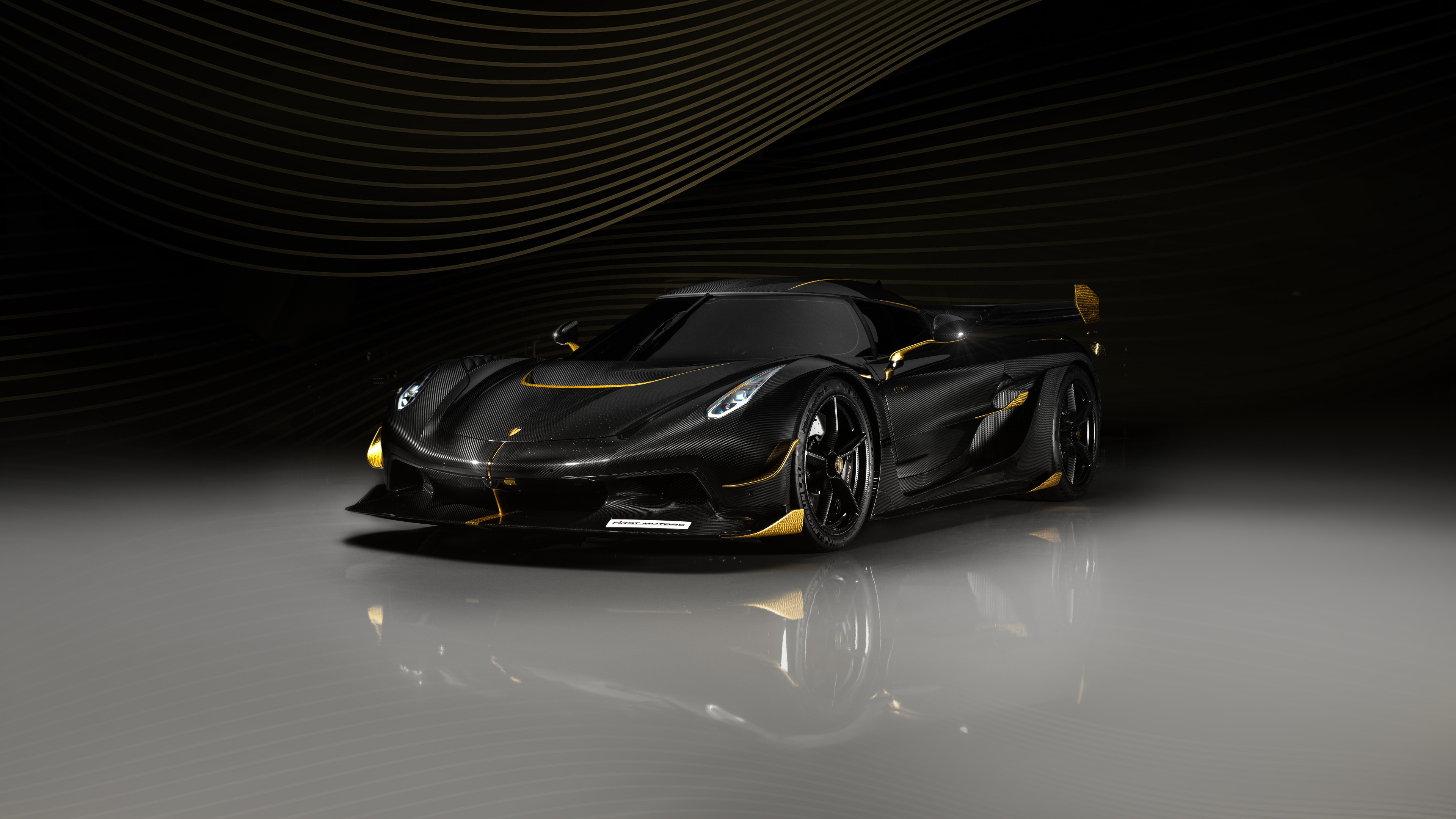 Extreme close-up of a carbon fiber hypercar's aerodynamic body in a dark, cinematic setting.