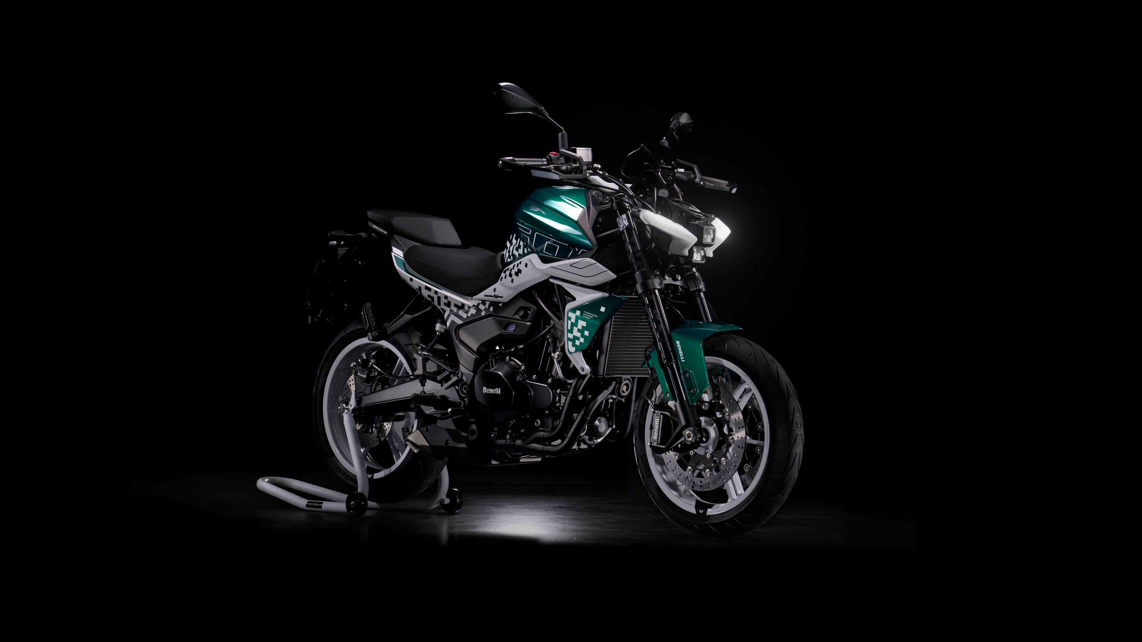 Close-up of detailed adventure motorcycles against a solid black background