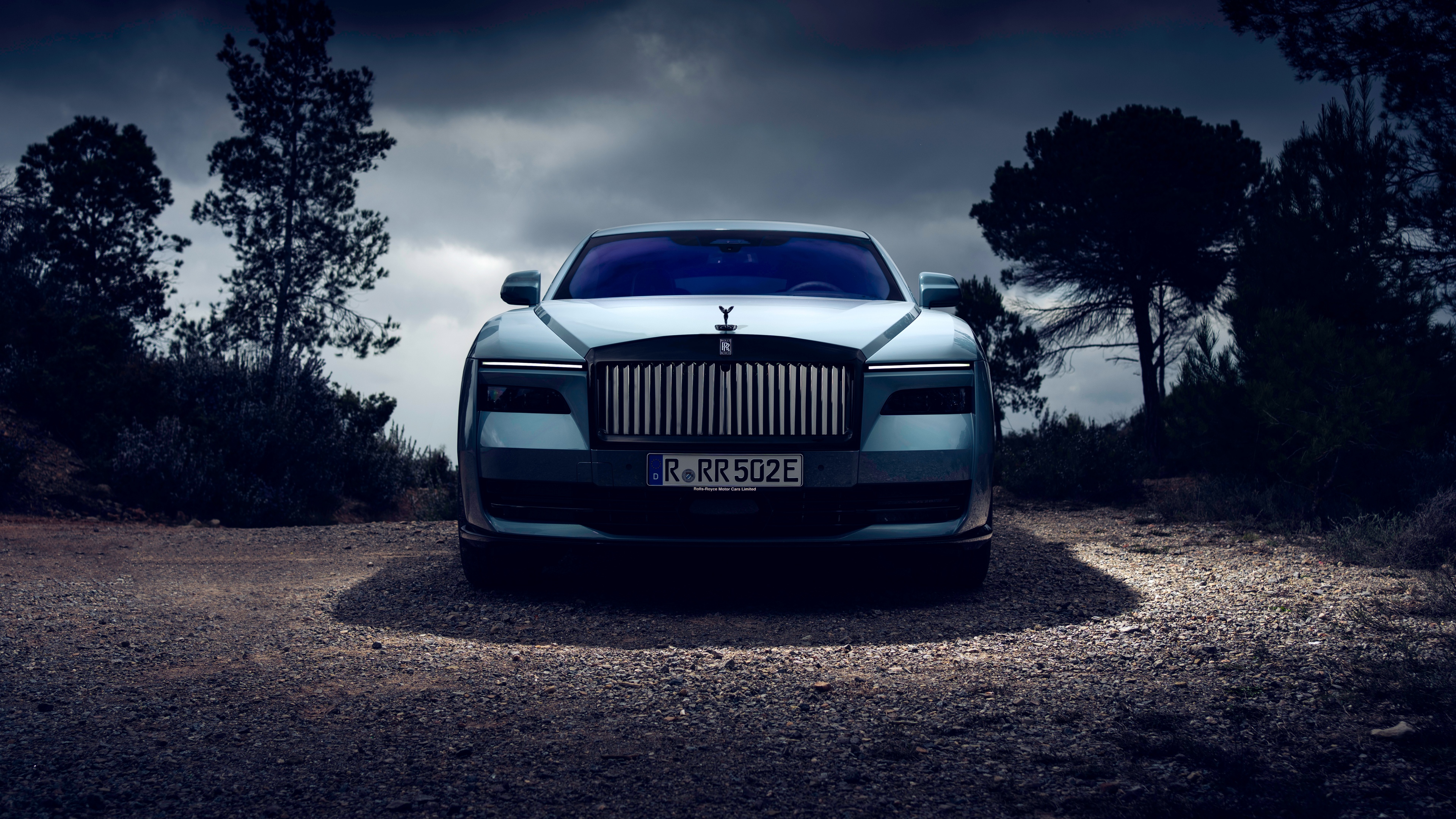 A high-resolution, dark aesthetic view of the Rolls-Royce Black Badge Spectre luxury electric car.