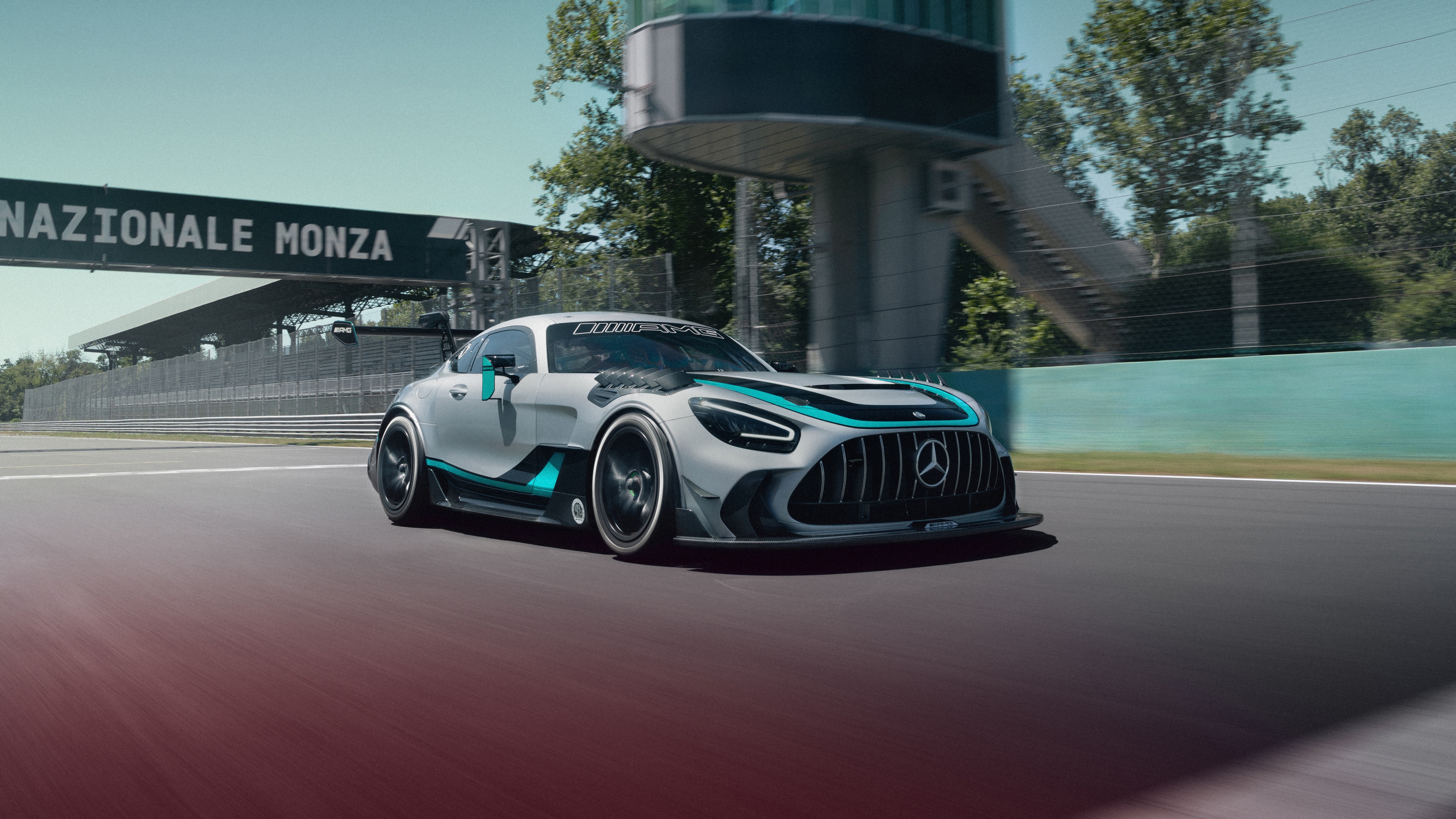 A sleek Mercedes-AMG GT2 Edition W16,5K racing car speeding through a corner on a professional circuit.