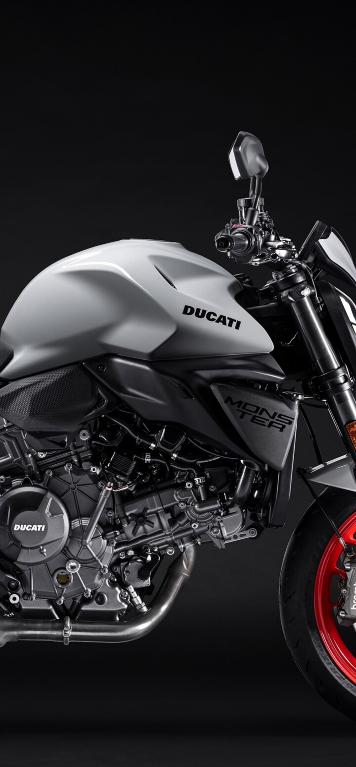 A high-detail shot of the 2026 Ducati Monster V2 sports motorcycle featuring a dark, minimalist background and sharp aerodynamic lines.