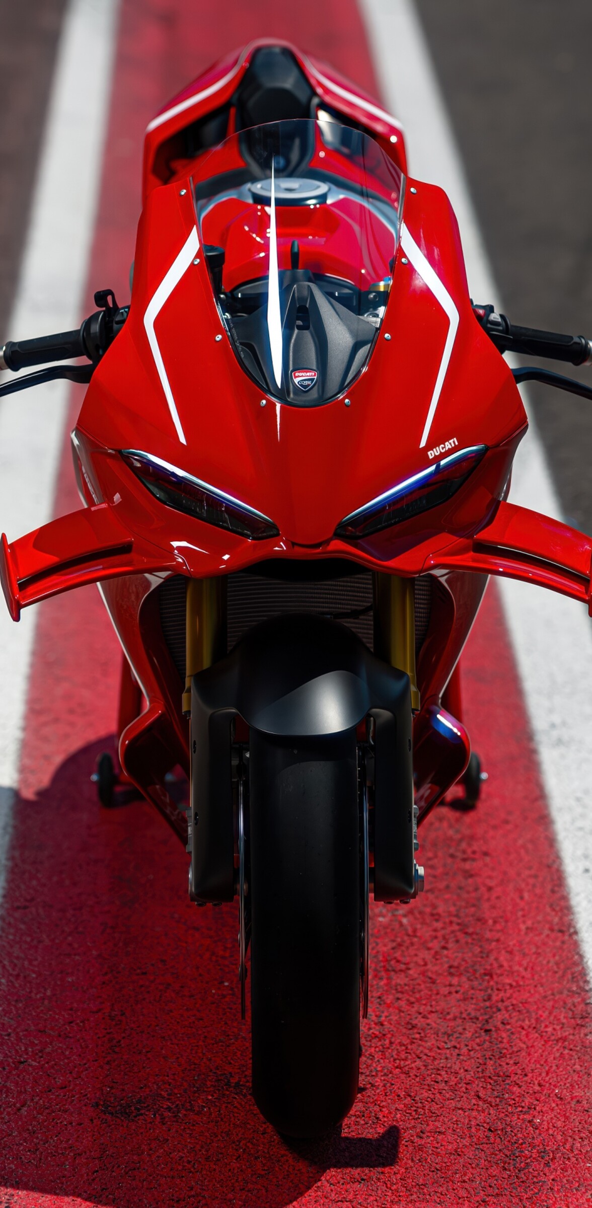 A high-detail view of a red 2026 Ducati Panigale V4 R sports motorcycle featuring aggressive aerodynamic fairings.